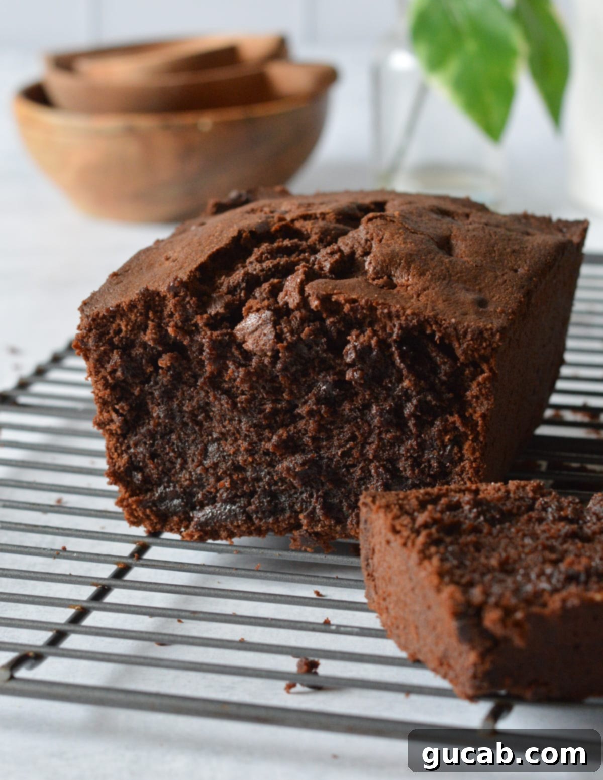 Decadent Gluten-Free Chocolate Pound Cake 12 A warm, freshly baked gluten-free chocolate pound cake, sliced in half, resting on a wire rack.