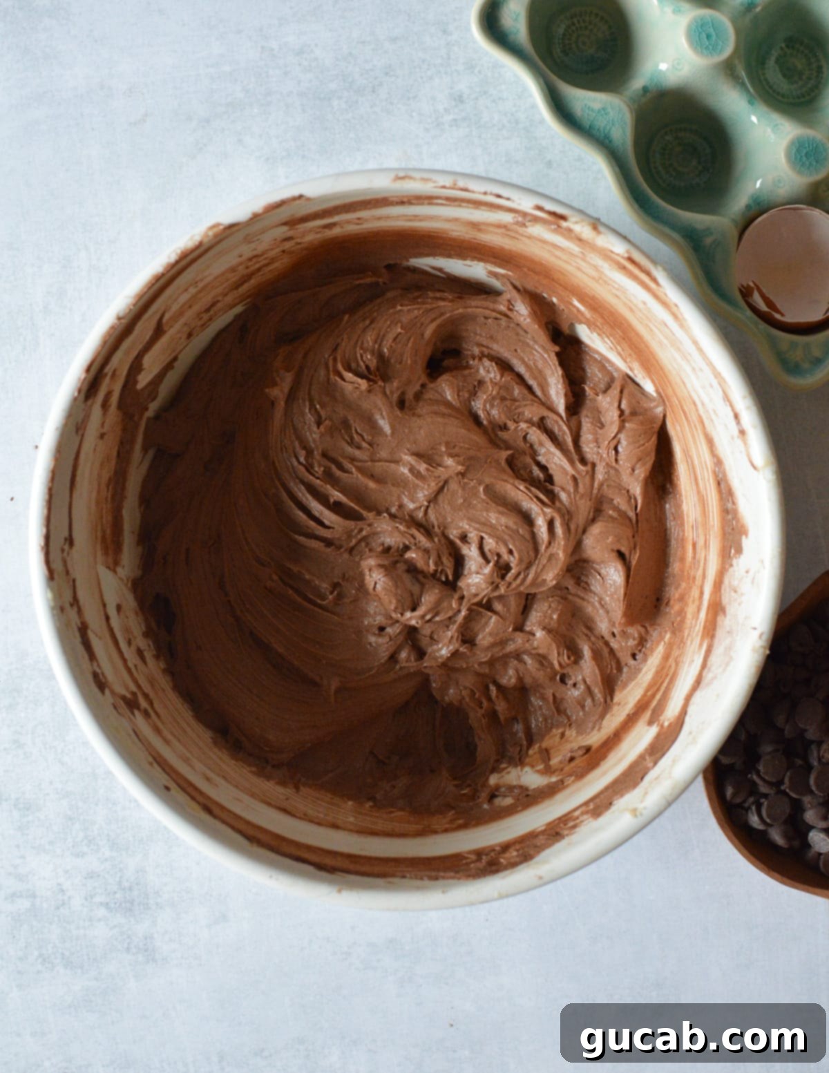 Decadent Gluten-Free Chocolate Pound Cake 10 A large bowl filled with rich, smooth gluten-free chocolate pound cake batter, studded with chocolate chips.