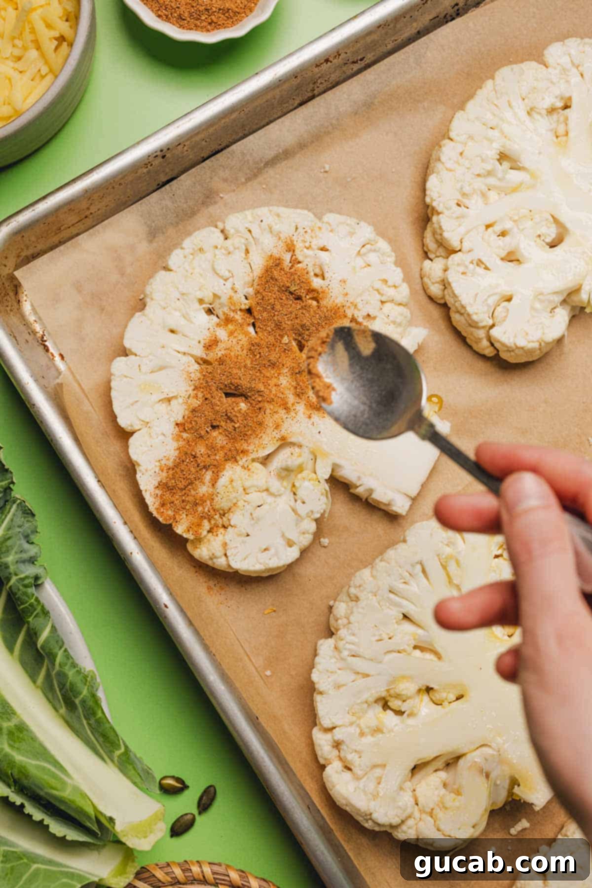 sprinkling taco seasoning onto cauliflower steaks 
