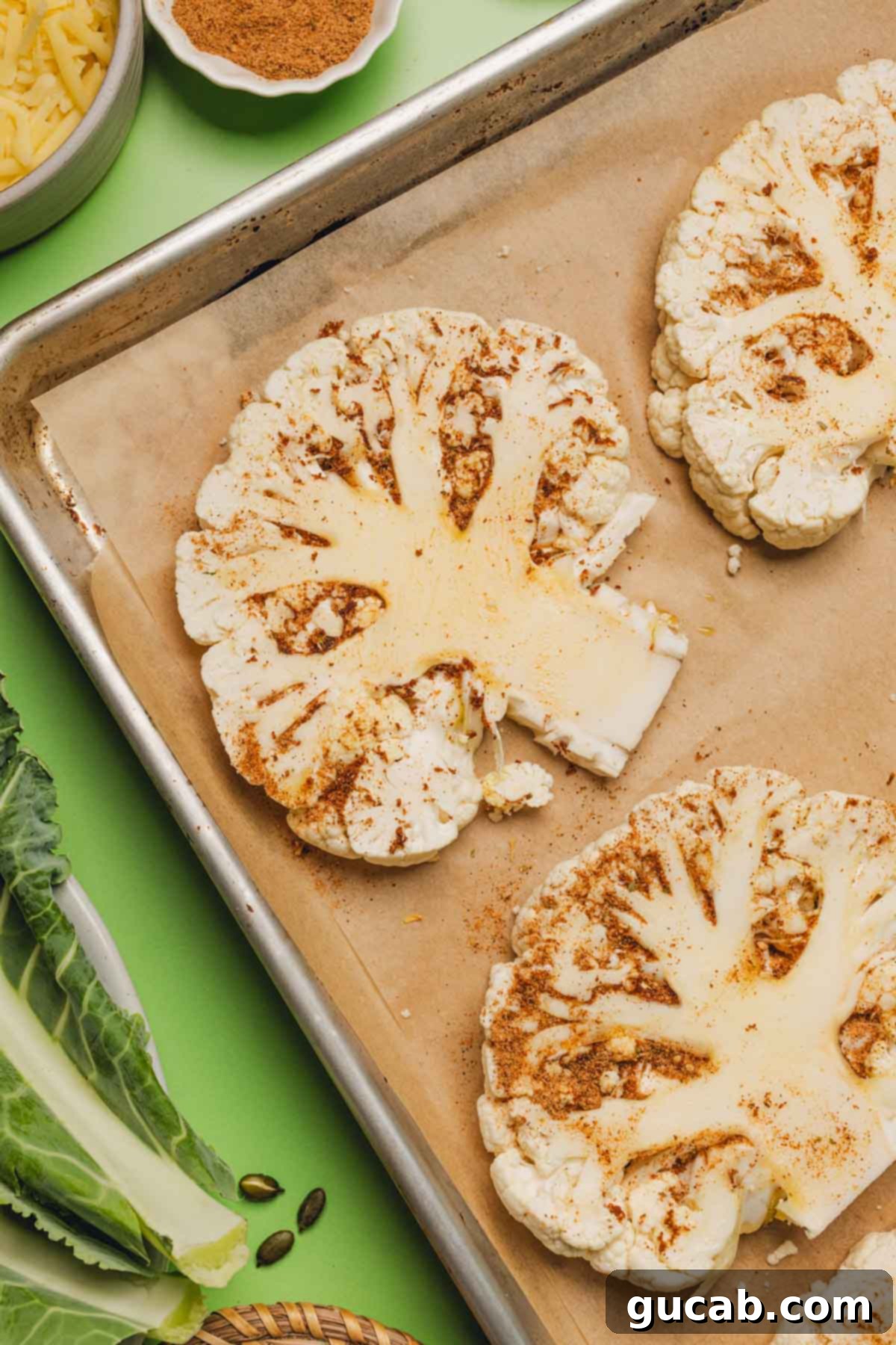 seasoned cauliflower steaks on a sheet pan 