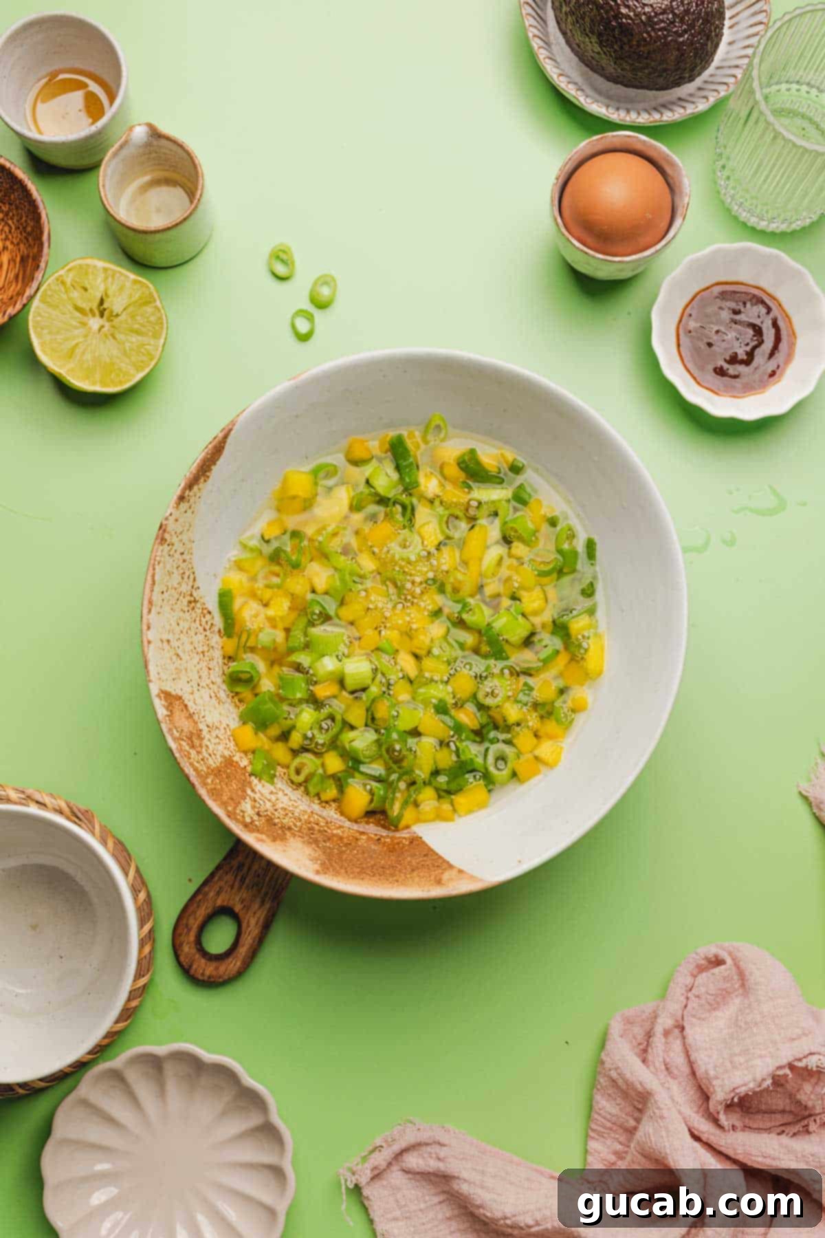 a bowl of pickled yellow bell peppers and green onions. 