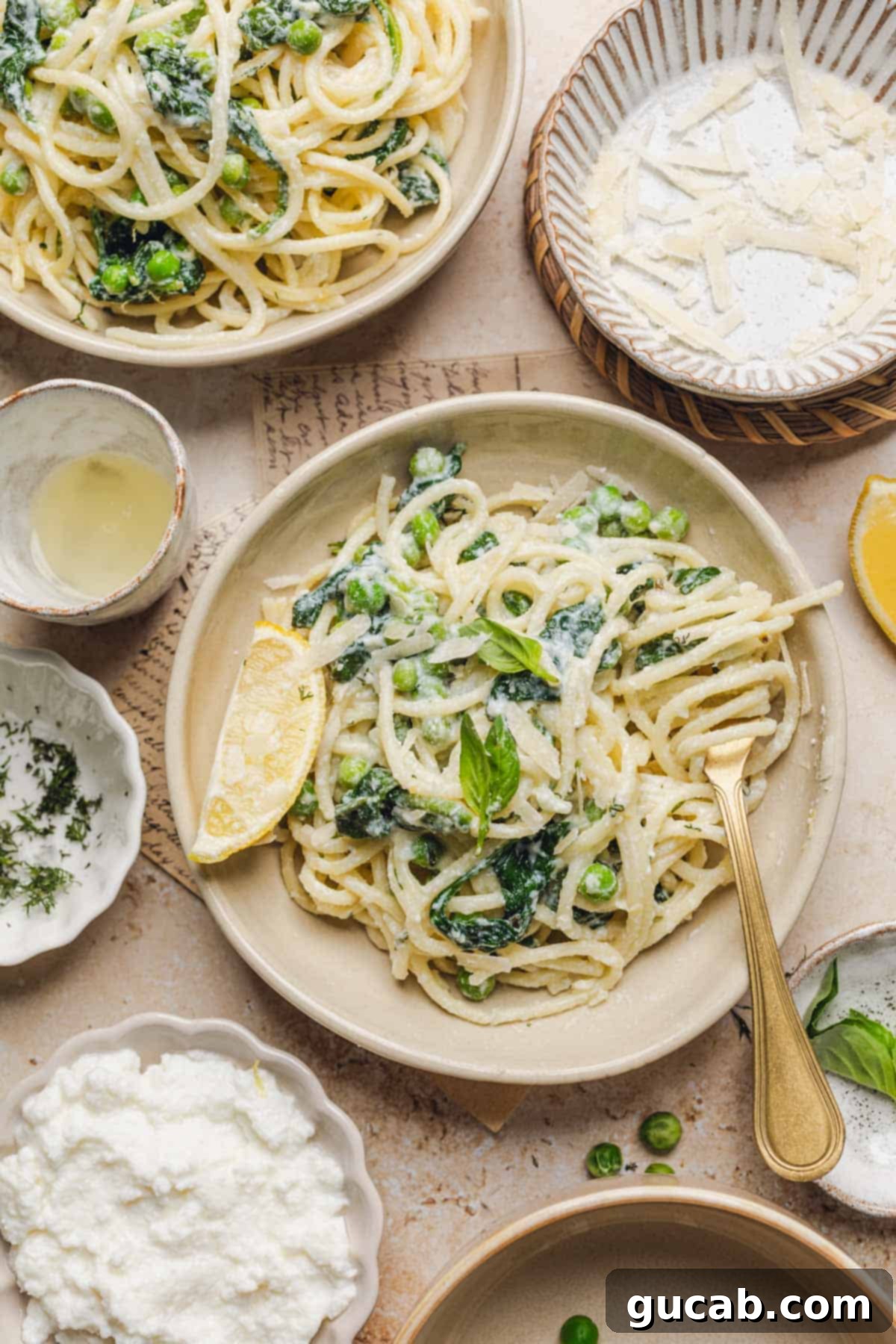 A plate with lemon ricotta pasta in it, garnished with a lemon wedge and a fork, highlighting its fresh and inviting appearance.
