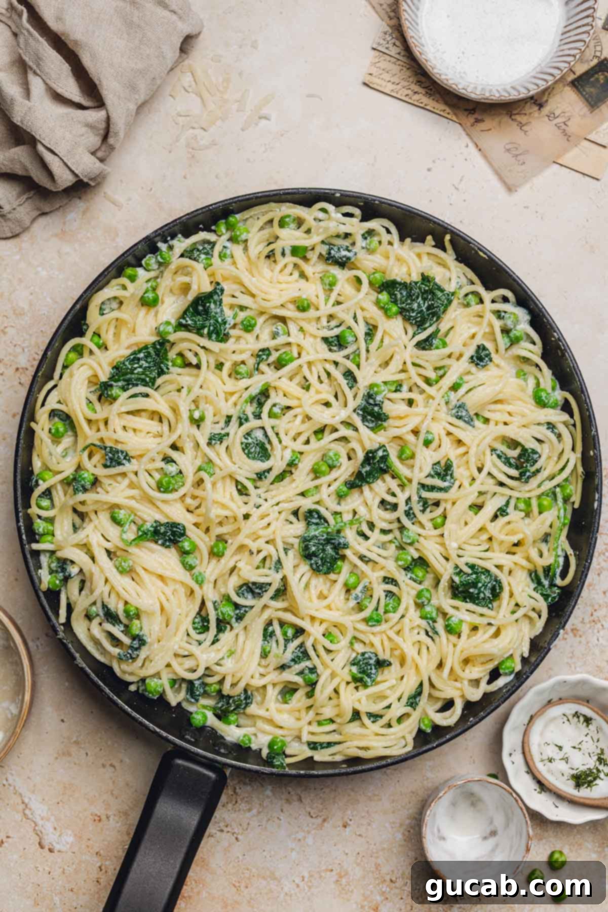 The finished lemon ricotta pasta simmering gently in the skillet, showing its creamy texture and vibrant ingredients.