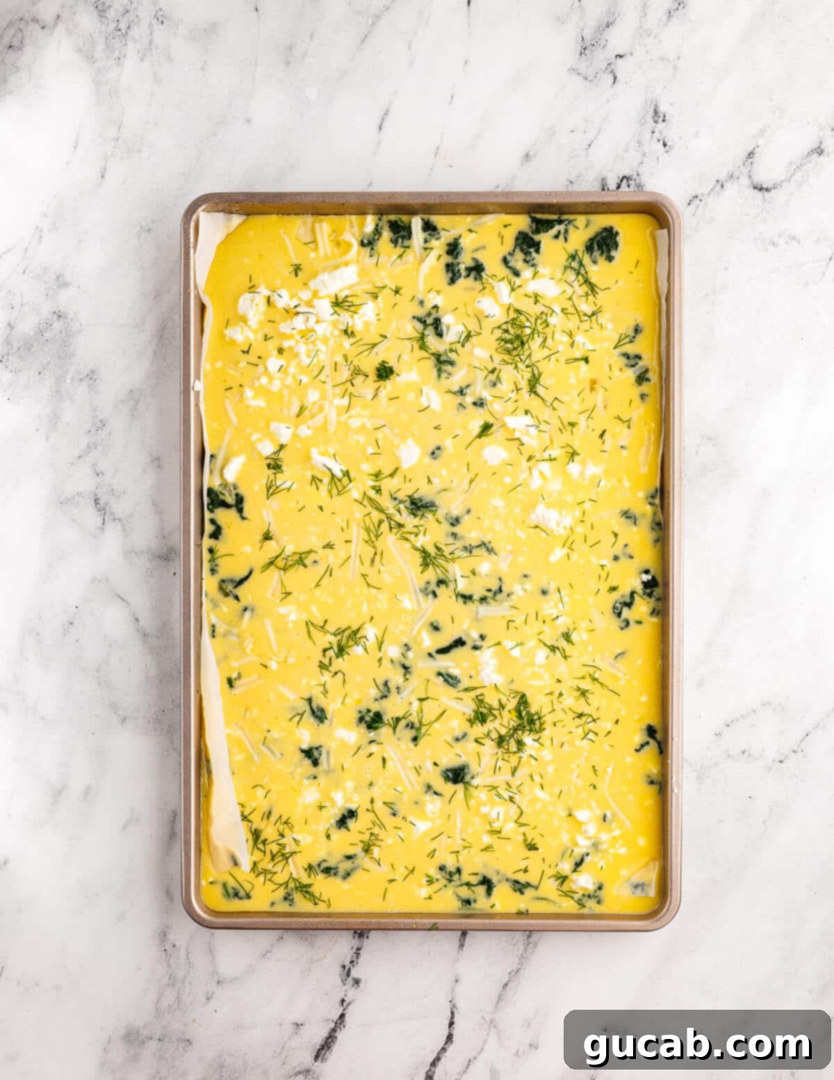 whisked eggs, feta, spinach, and mozzarella in a sheet pan. 