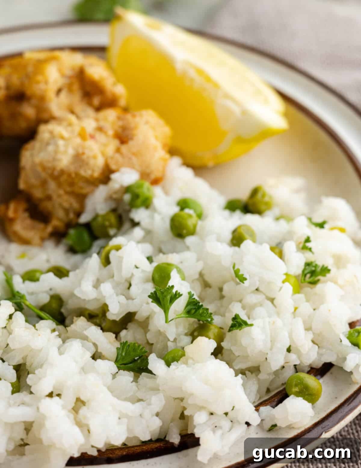 A serving of vibrant herb rice with peas on a white plate, garnished with fresh herbs.