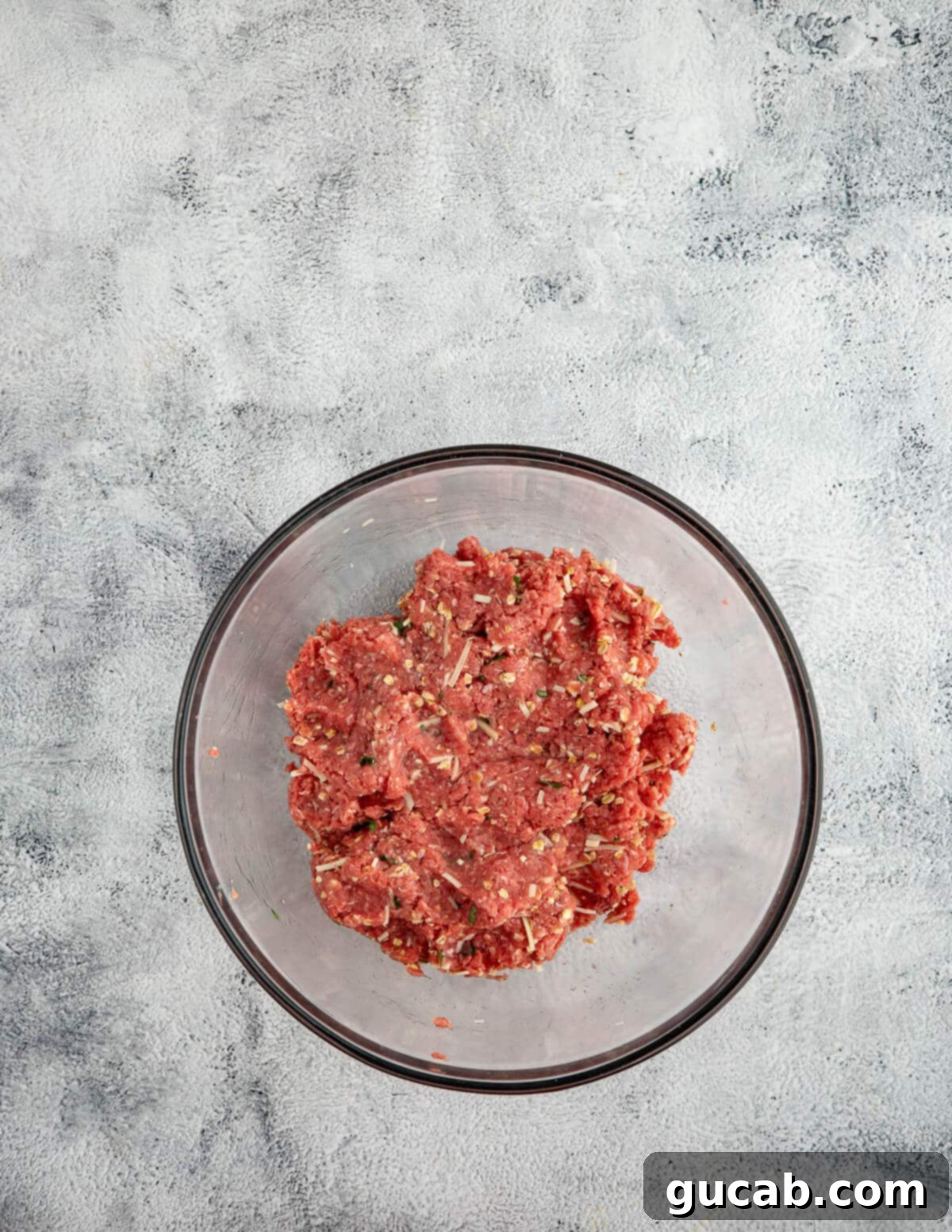 One-Pan Cheesy Meatballs 6 a bowl of meat mixed with oats and spices for meatballs.