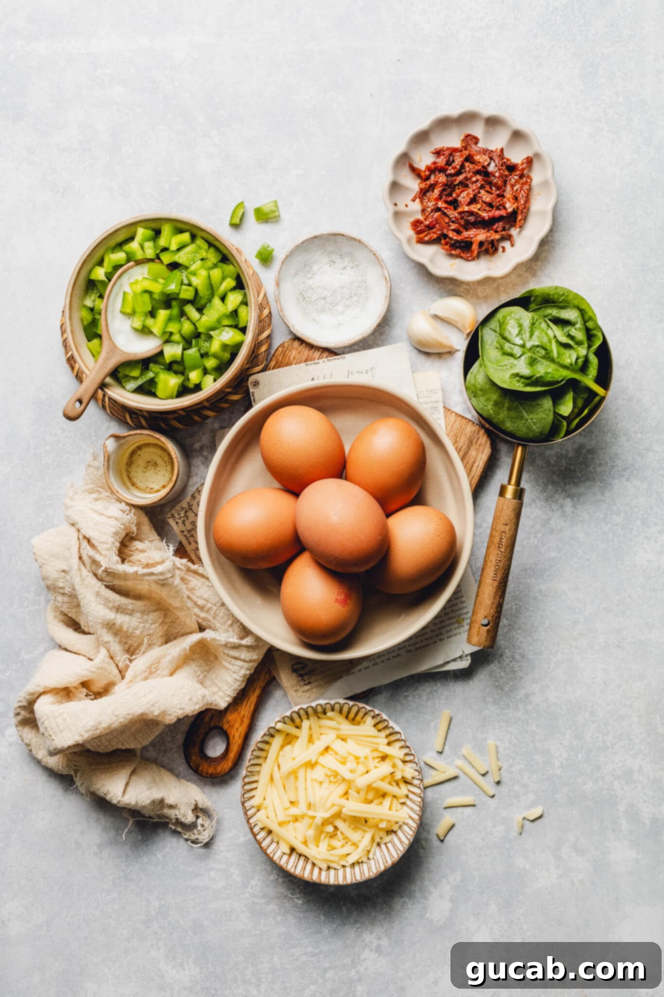 eggs, sun-dried tomatoes, garlic, salt, olive oil, shredded cheese, baby spinach.