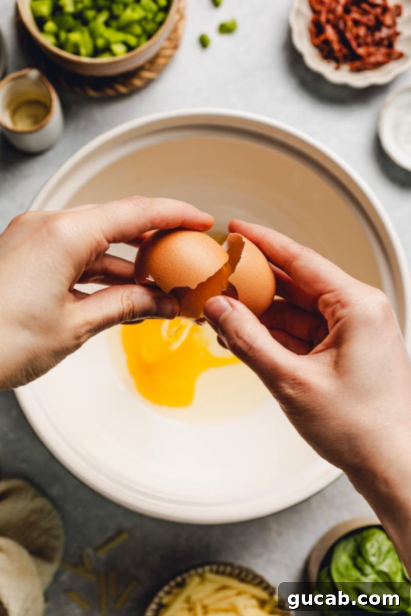 hand cracking egg into a bowl