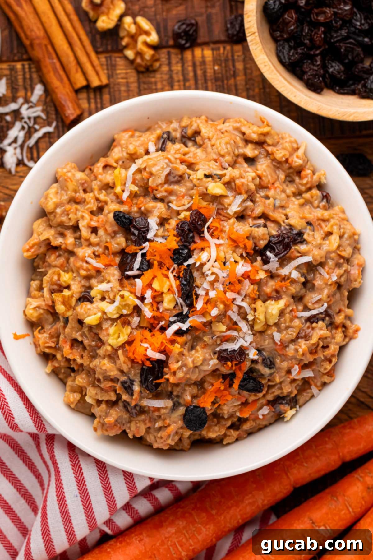 A comforting bowl of carrot cake oatmeal, elegantly topped with shredded carrots and plump raisins, capturing the essence of the classic dessert in a breakfast form.