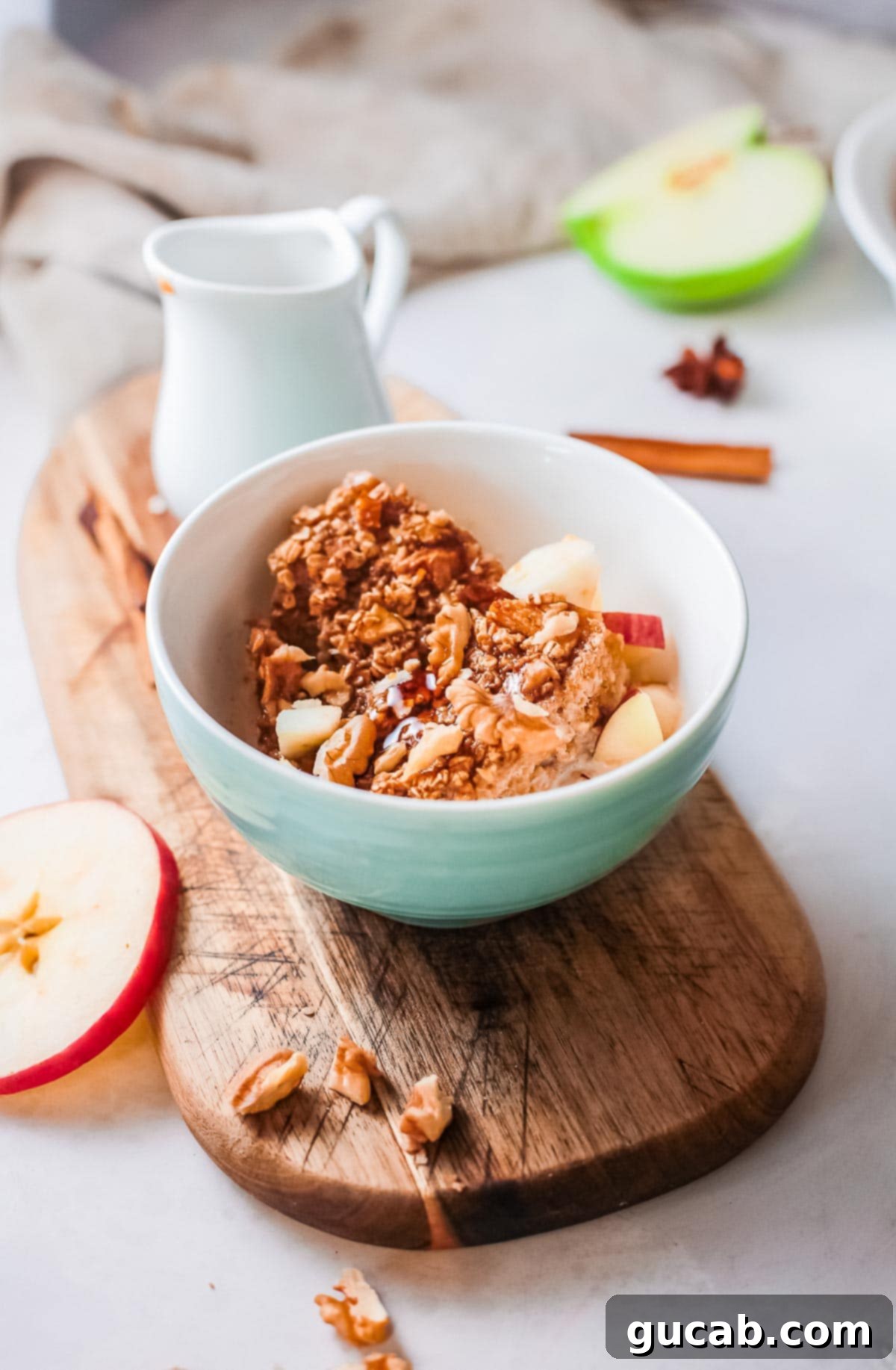 A warm and inviting bowl of baked apple oatmeal, with visible apple chunks and a hint of cinnamon, offering a hearty and comforting breakfast.