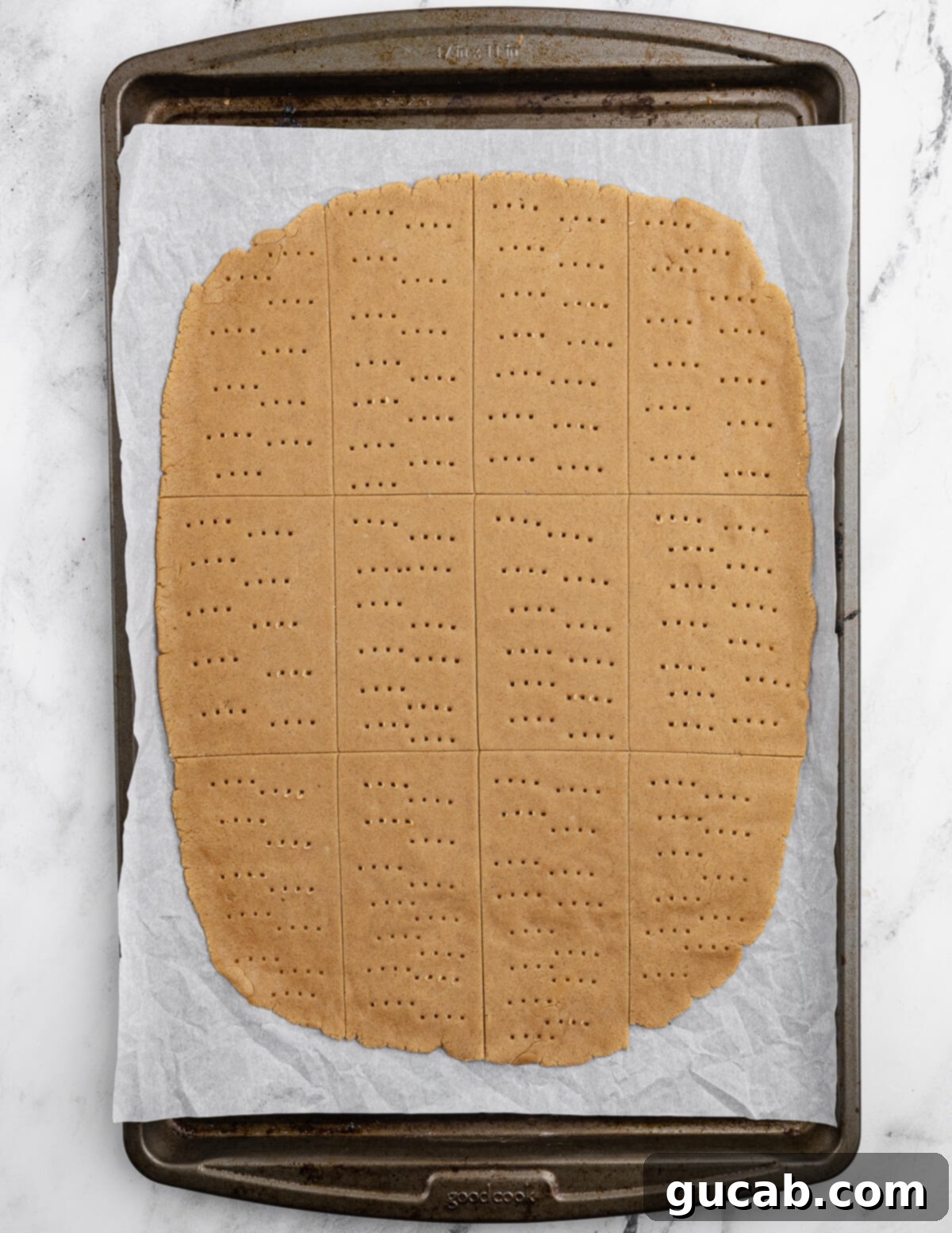 Golden Gluten-Free Graham Delights 12 rolled out graham cracker cookie dough on a sheet pan, ready for baking.