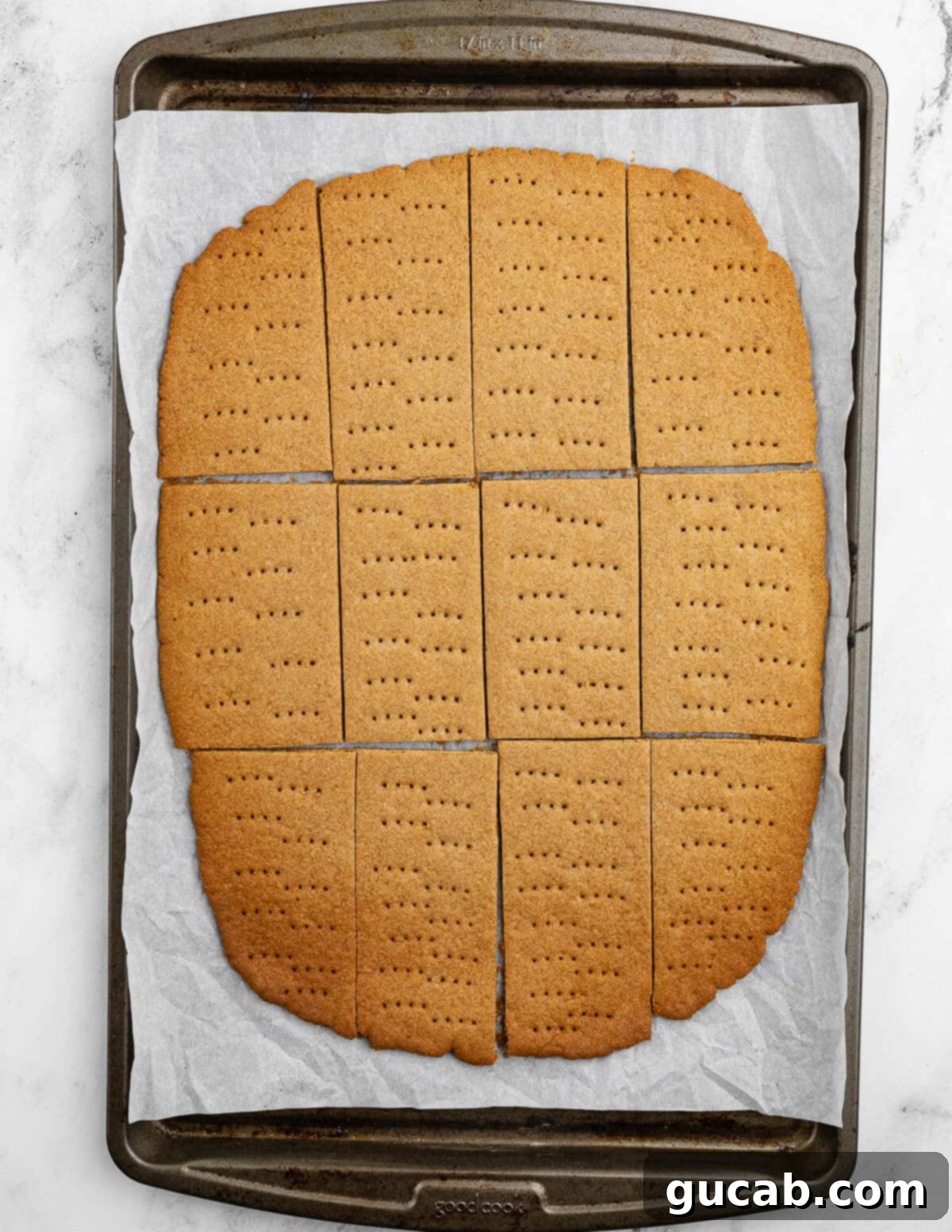 Golden Gluten-Free Graham Delights 13 baked gluten-free graham crackers on a sheet pan, just out of the oven.