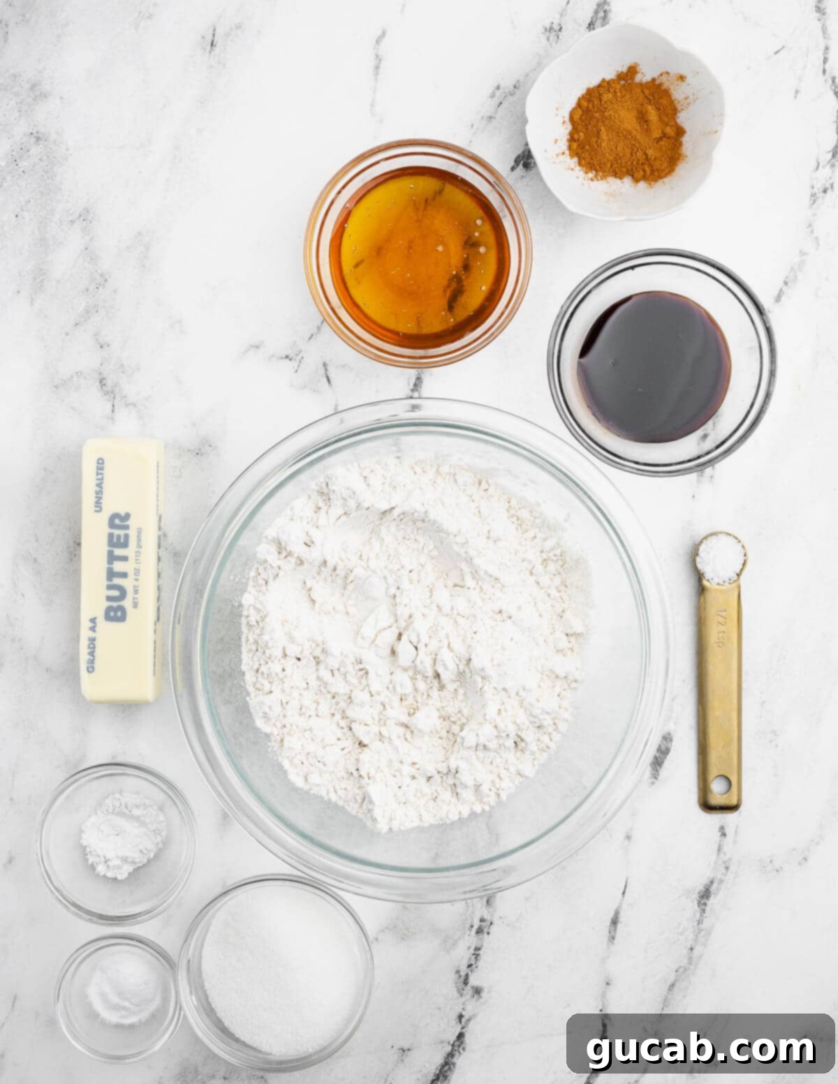 Golden Gluten-Free Graham Delights 3 Various ingredients for gluten-free graham crackers laid out: butter, gluten-free flour, honey, cinnamon, salt, water, sugar, baking powder, and molasses.