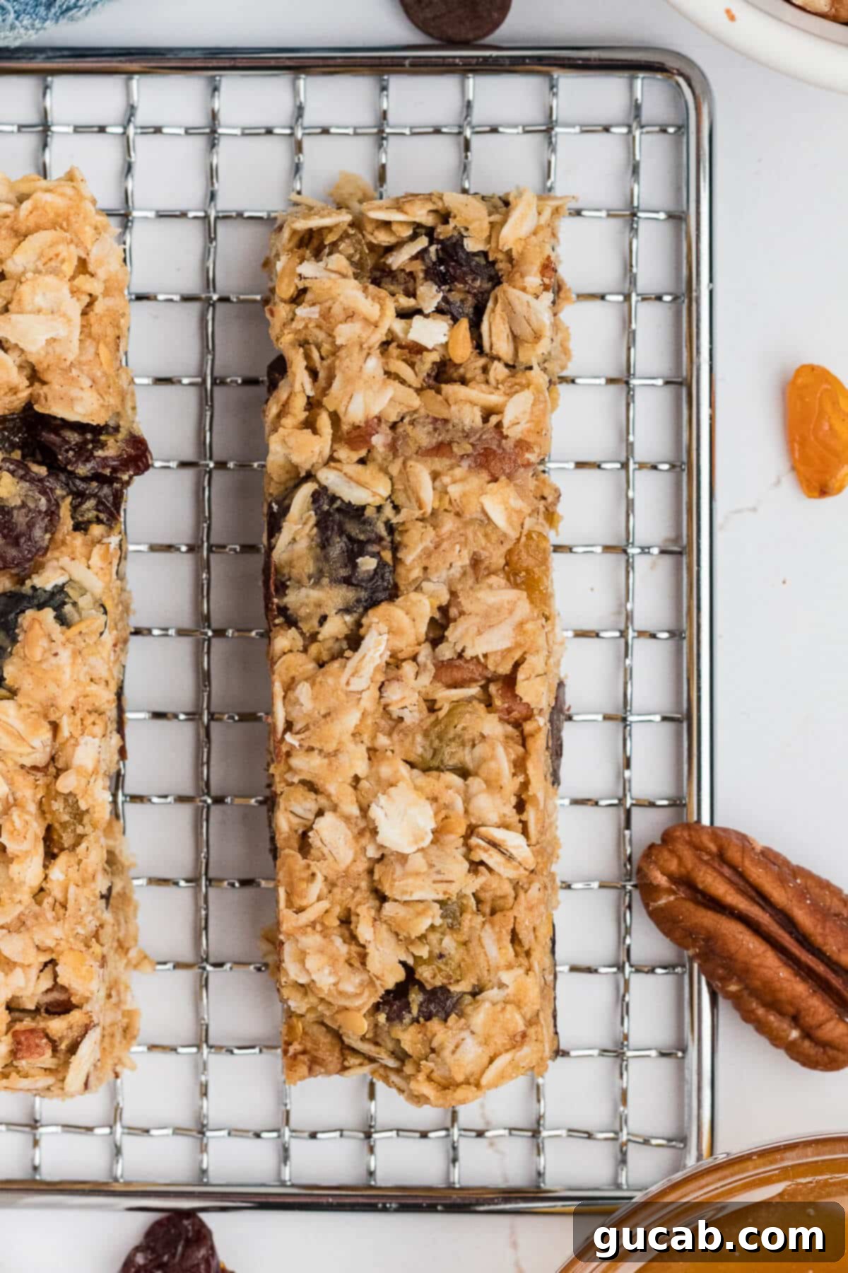A single, perfectly formed granola bar resting on a wire rack, showcasing its ideal texture and readiness for enjoyment after being fully chilled.