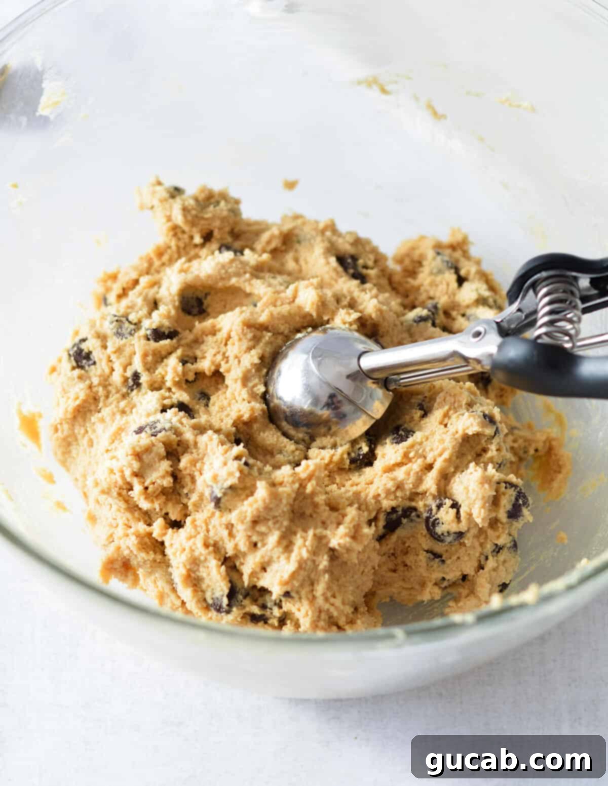 A close-up of the finished peanut butter chocolate chip cookie dough, studded with chocolate chips, ready for scooping.