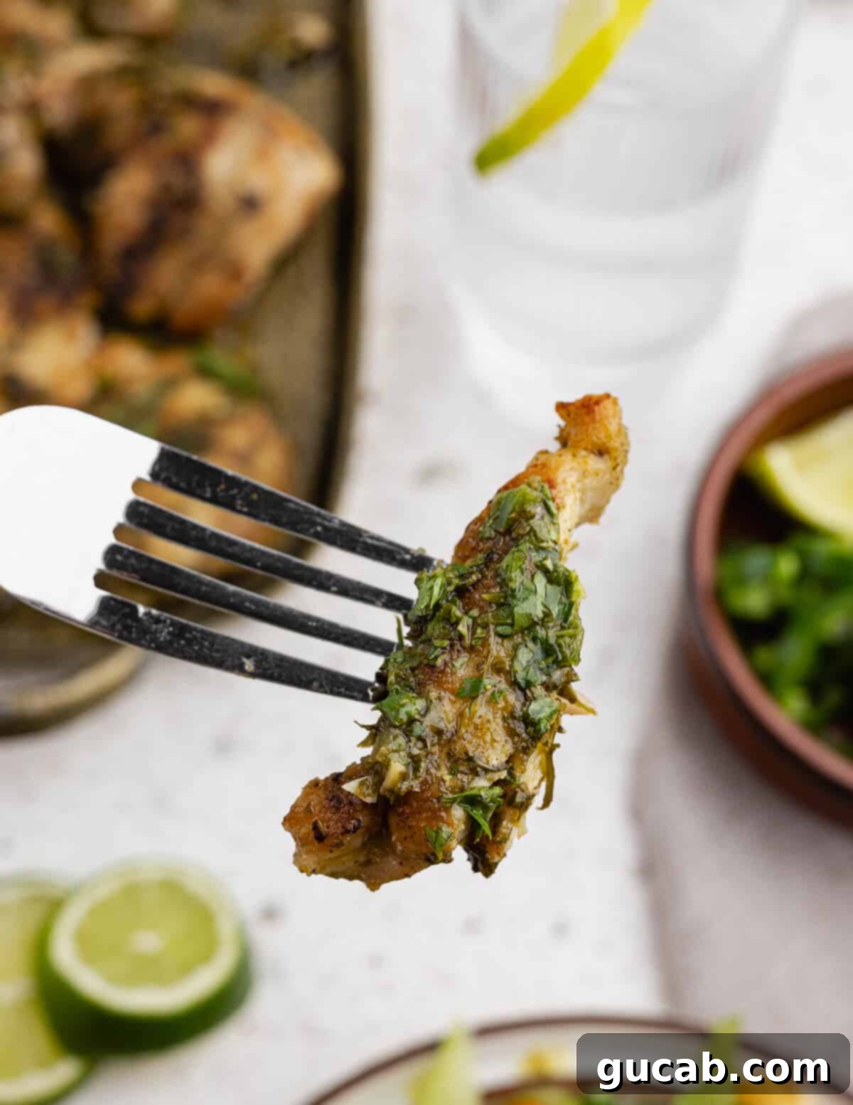 Zesty Chimichurri Chicken Thighs 12 A delicious bite of chimichurri chicken on a fork, showing the tender meat and rich herb sauce.