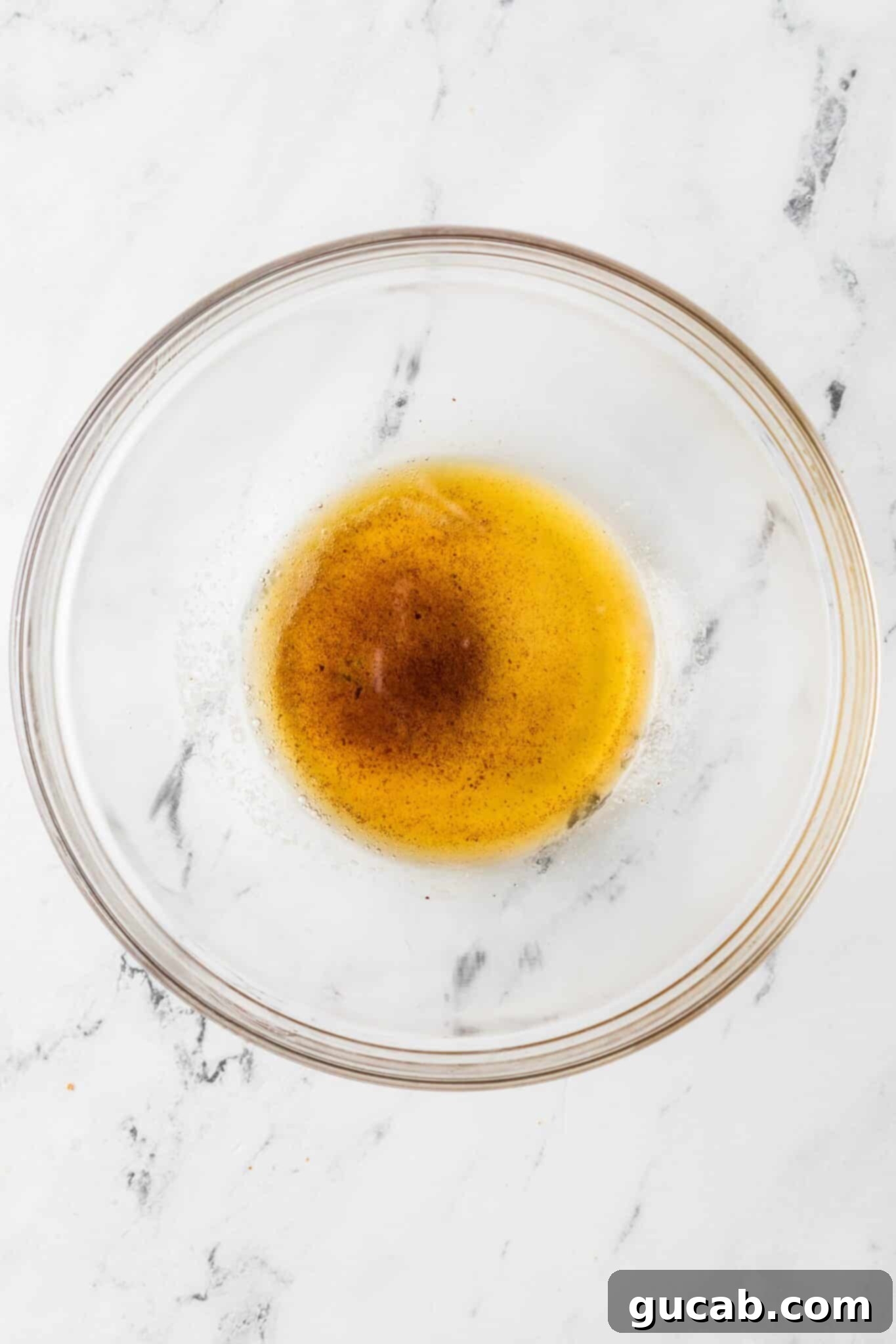 Perfectly melted and browned butter poured into a bowl, showcasing the rich amber color and nutty brown solids.