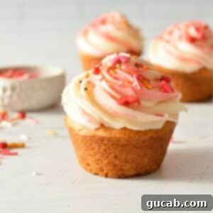 A perfectly baked and frosted gluten-free vanilla cupcake, ready to be enjoyed.