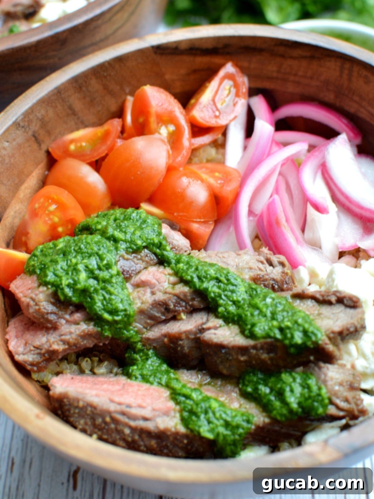 Close-up of perfectly cooked and sliced chimichurri steak, showcasing its beautiful texture and vibrant topping.