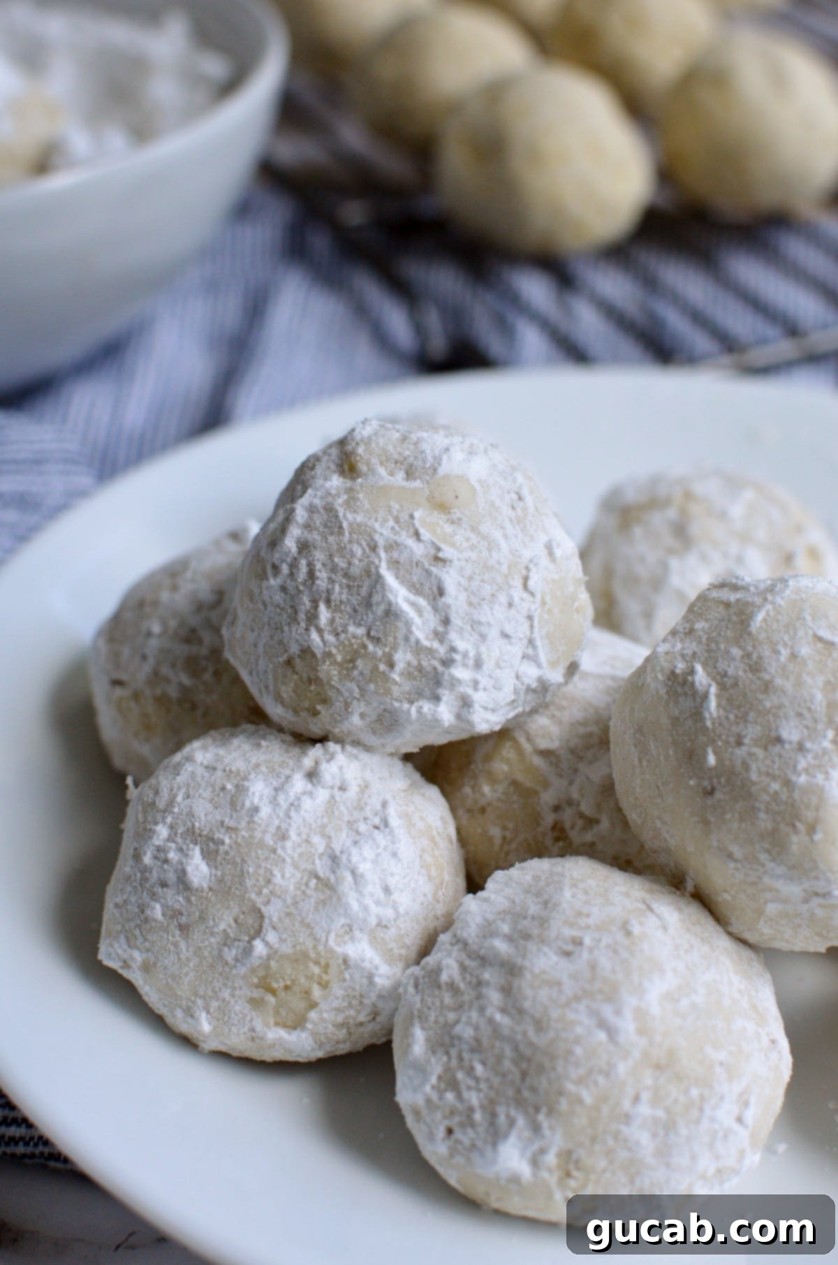 gluten free snowball cookies, perfectly round and coated in powdered sugar