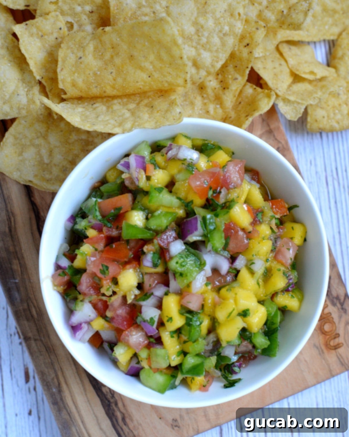 Freshly made mango habanero salsa in a bowl with tortilla chips