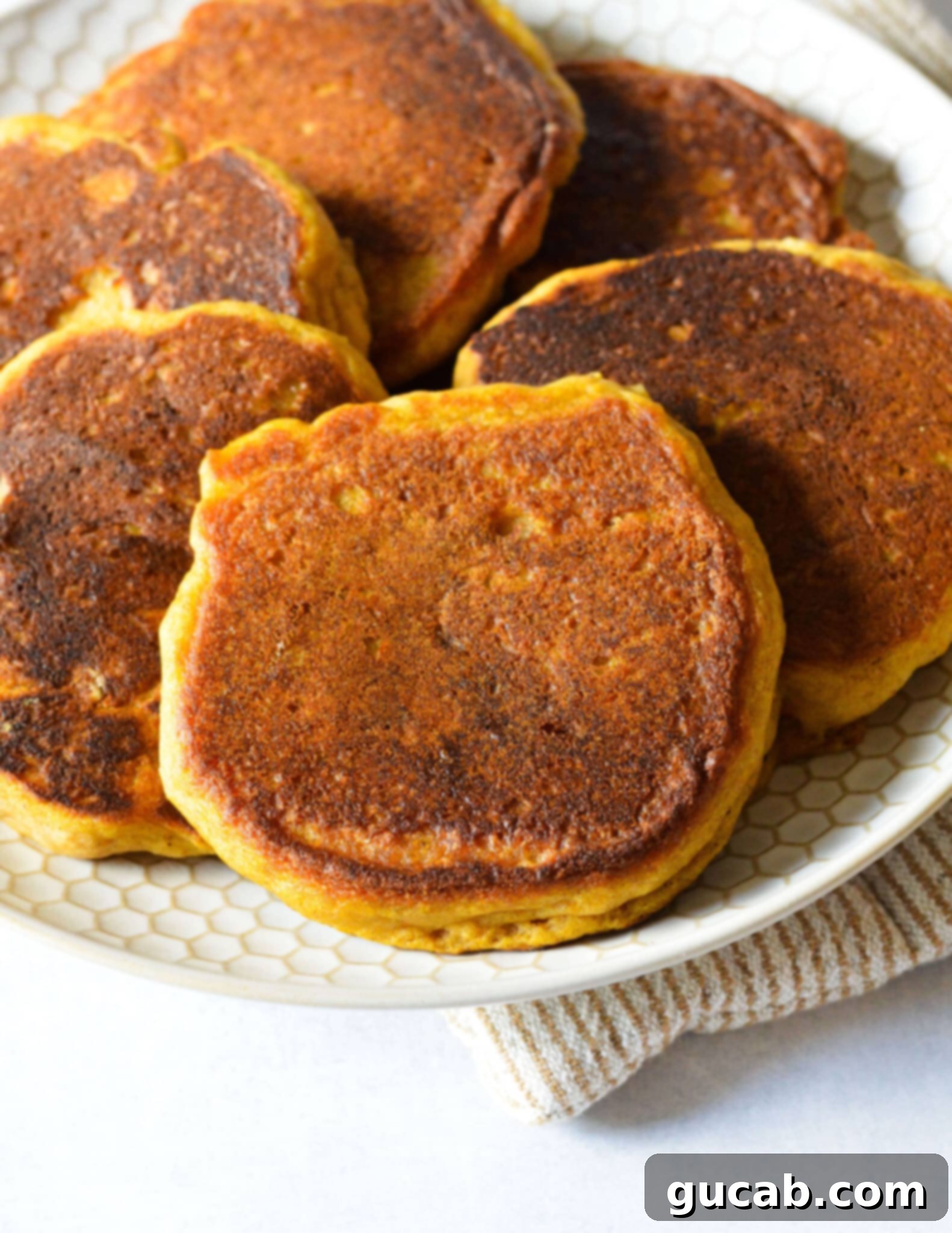 a plate full of gluten free pumpkin pancakes. 