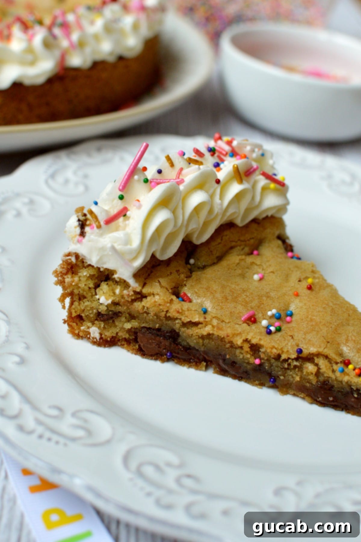 Ultimate Gluten-Free Cookie Cake 2 a slice of gluten free cookie cake on a plate, showing its soft texture and chocolate chips