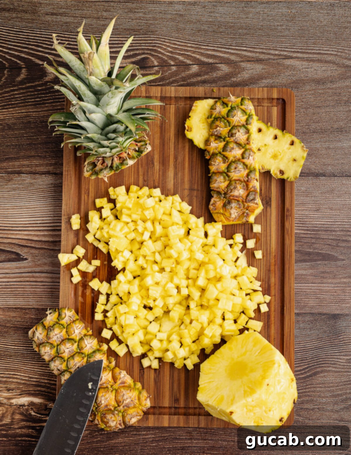 small diced pineapple on a cutting board. 