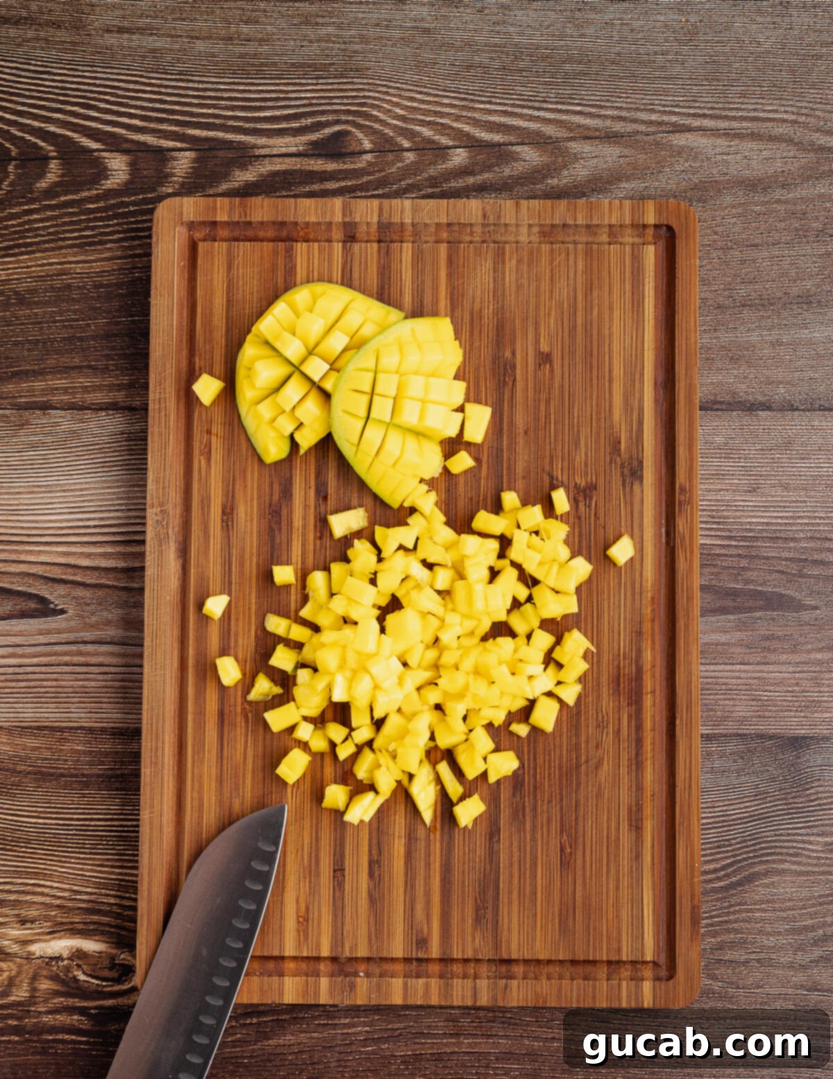 small diced mango on a cutting board. 