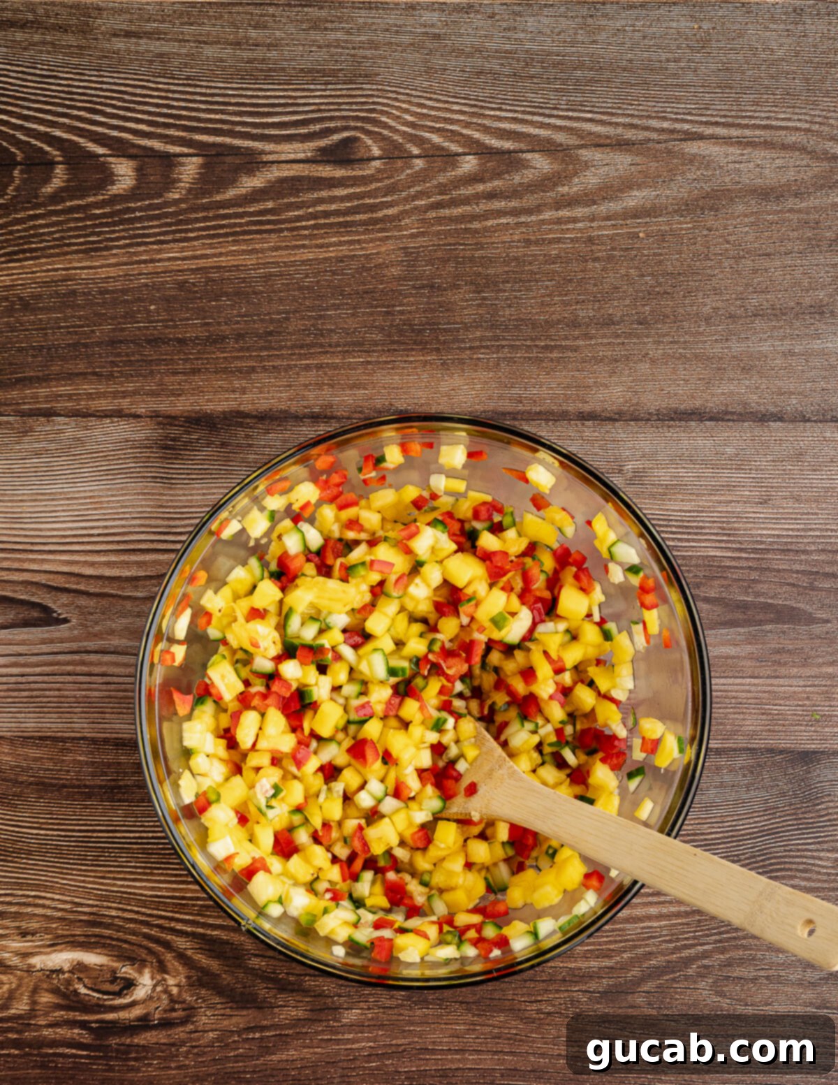 bowl of pineapple mango salsa with ingredients before mixing.