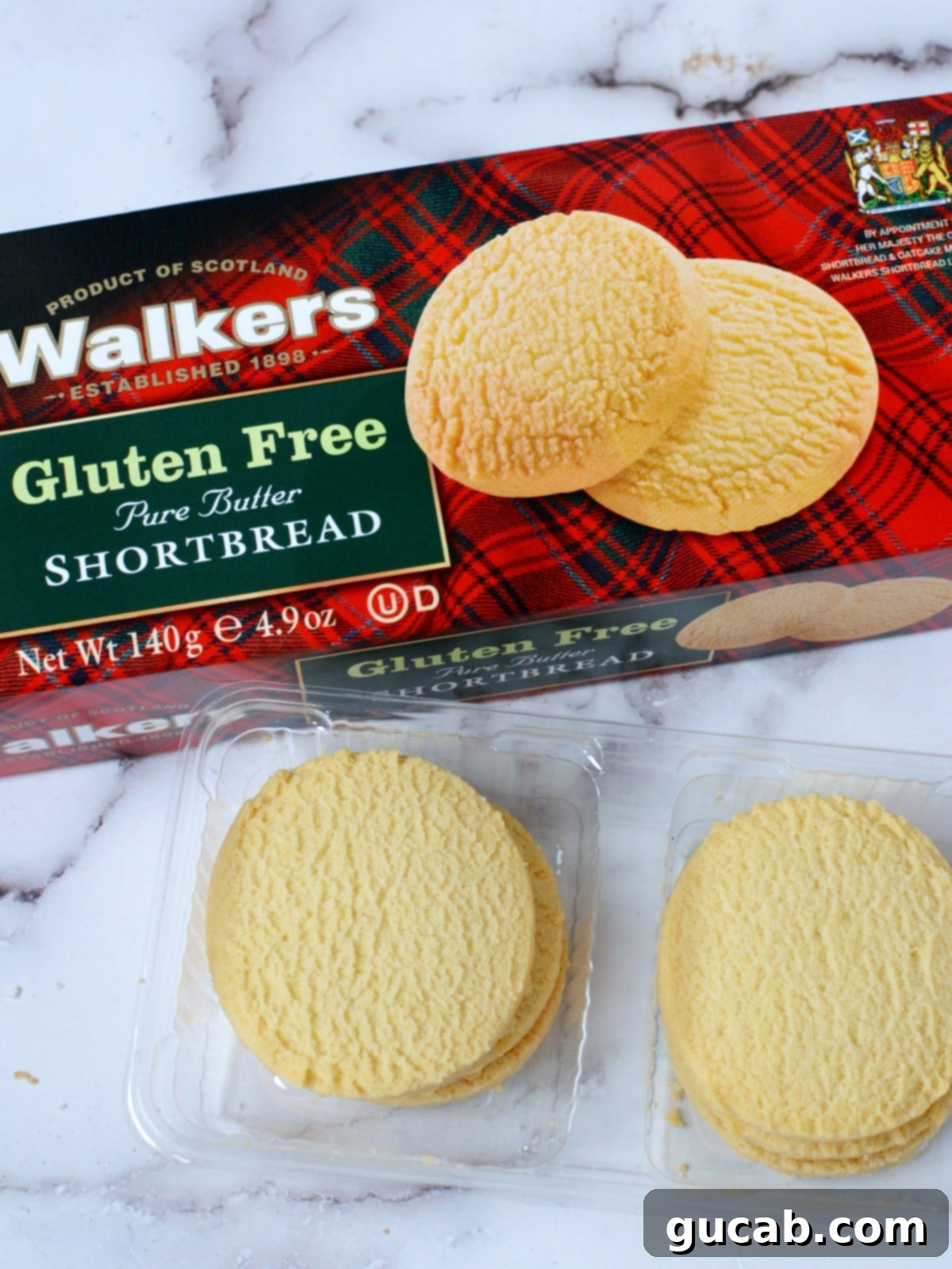 Walkers Gluten Free Pure Butter Shortbread cookies, arranged on a plate with a classic tartan background.