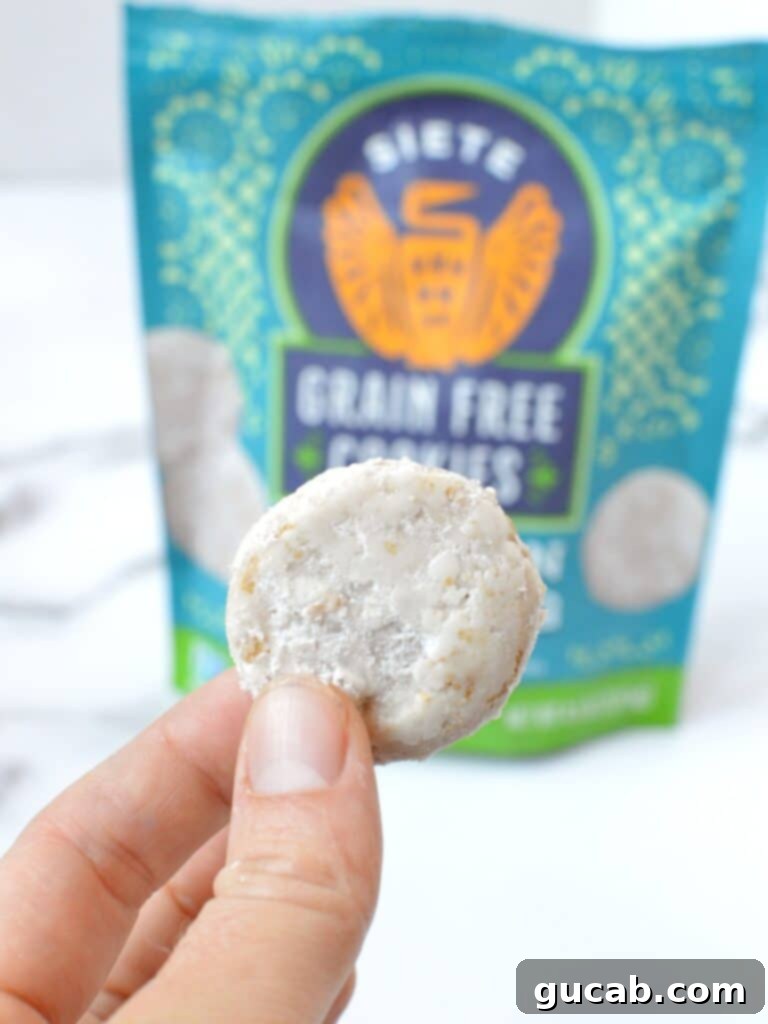 Siete Grain Free Mexican Wedding Cookies, lightly dusted with powdered sugar, arranged on a plate.