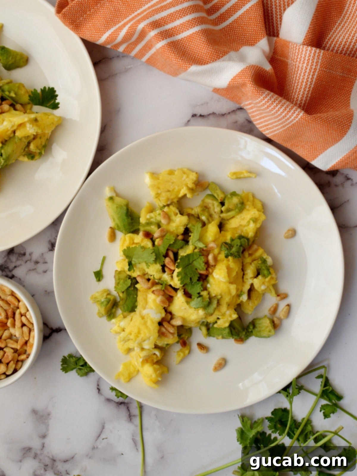Creamy avocado scrambled eggs with fresh toppings