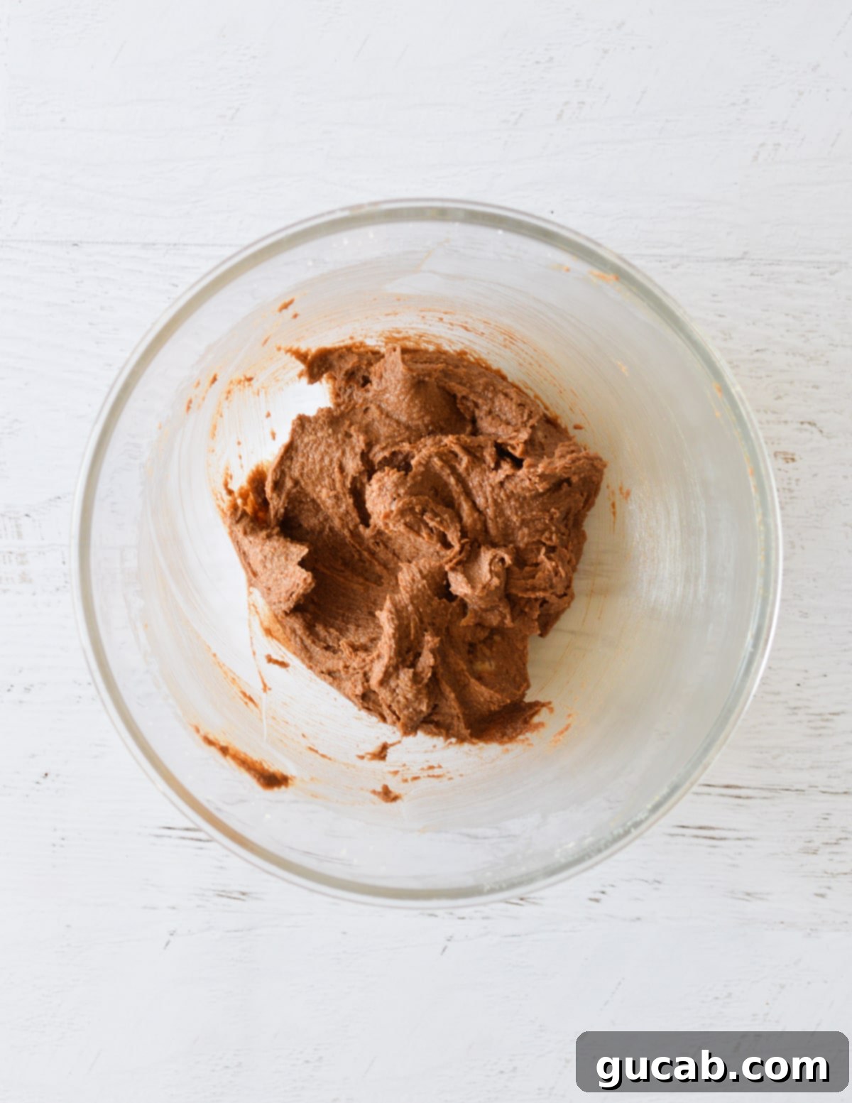 The butter and chocolate mixture fully combined, forming a rich, dark base.