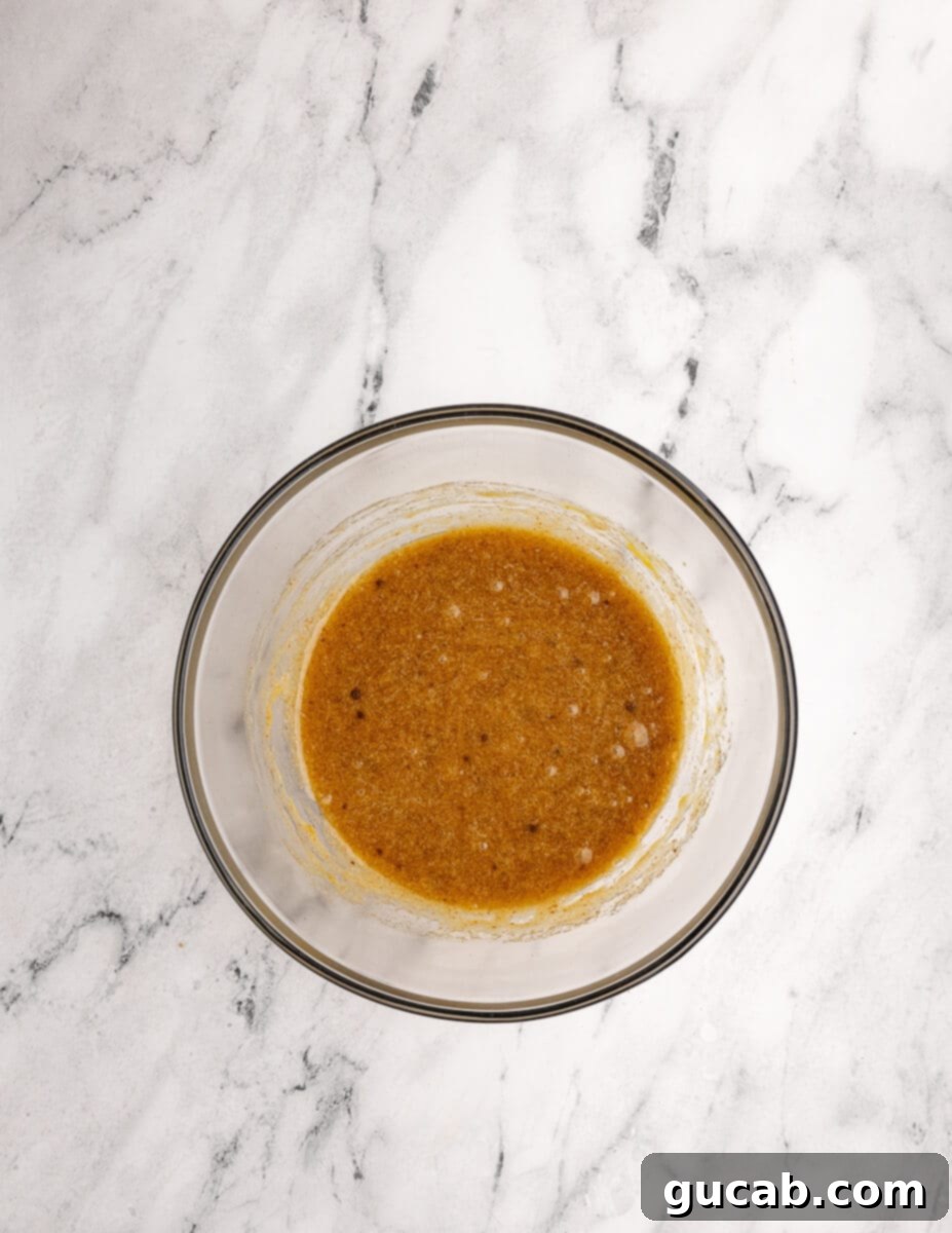 a bowl of mixed sugar, browned butter, and eggs. 