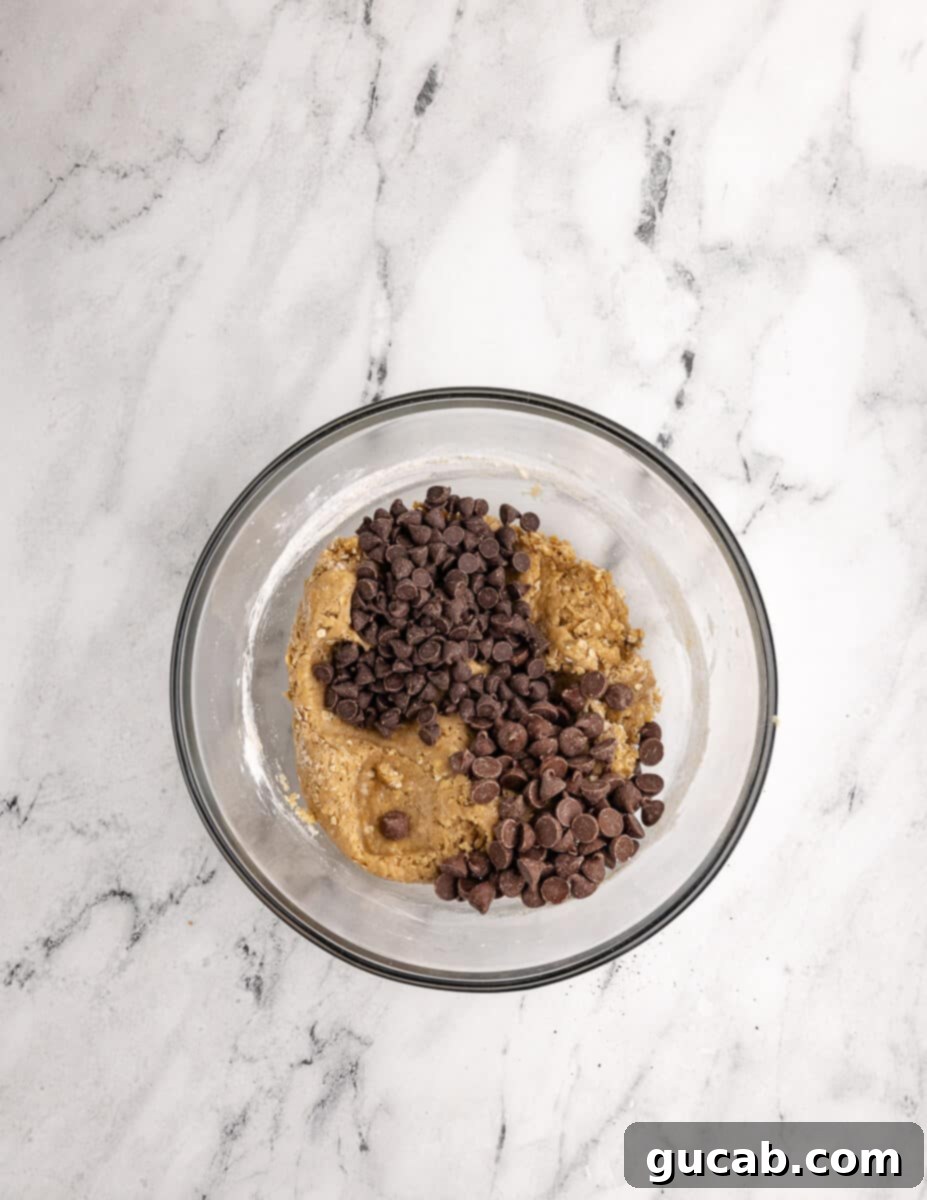 a bowl of gluten free cookie dough with chocolate chips on top. 
