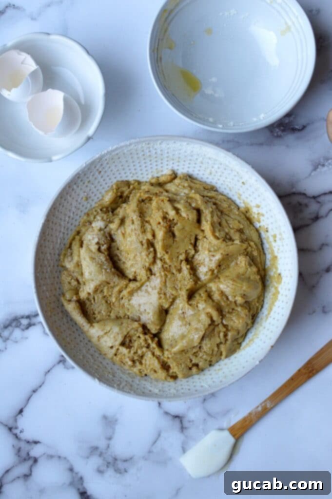 Exquisite Gluten-Free Pistachio Cake 5 Adding dry ingredients, including gluten-free flour and ground pistachios, to the wet mixture