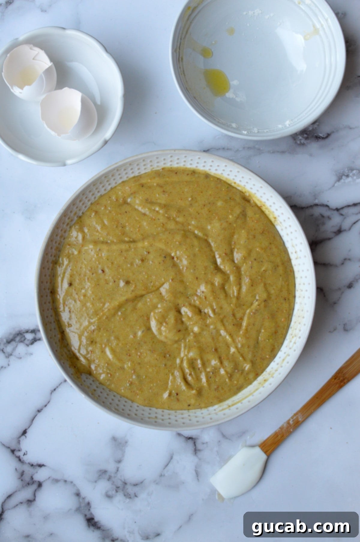 Exquisite Gluten-Free Pistachio Cake 6 Smooth, green pistachio cake batter in a mixing bowl