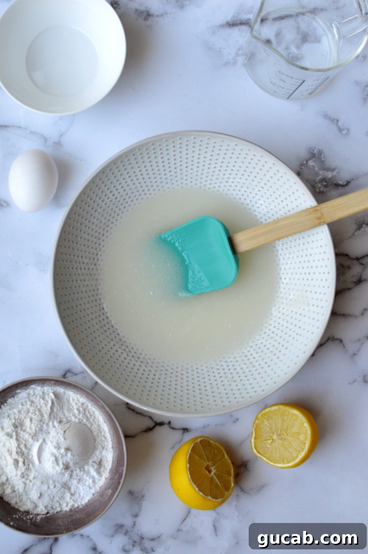 A bowl containing oil and sugar mixed together for muffin batter