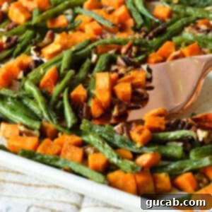 Perfectly Roasted Green Beans and Sweet Potatoes 11 roasted green beans, sweet potatoes, and pecans on a sheet pan.