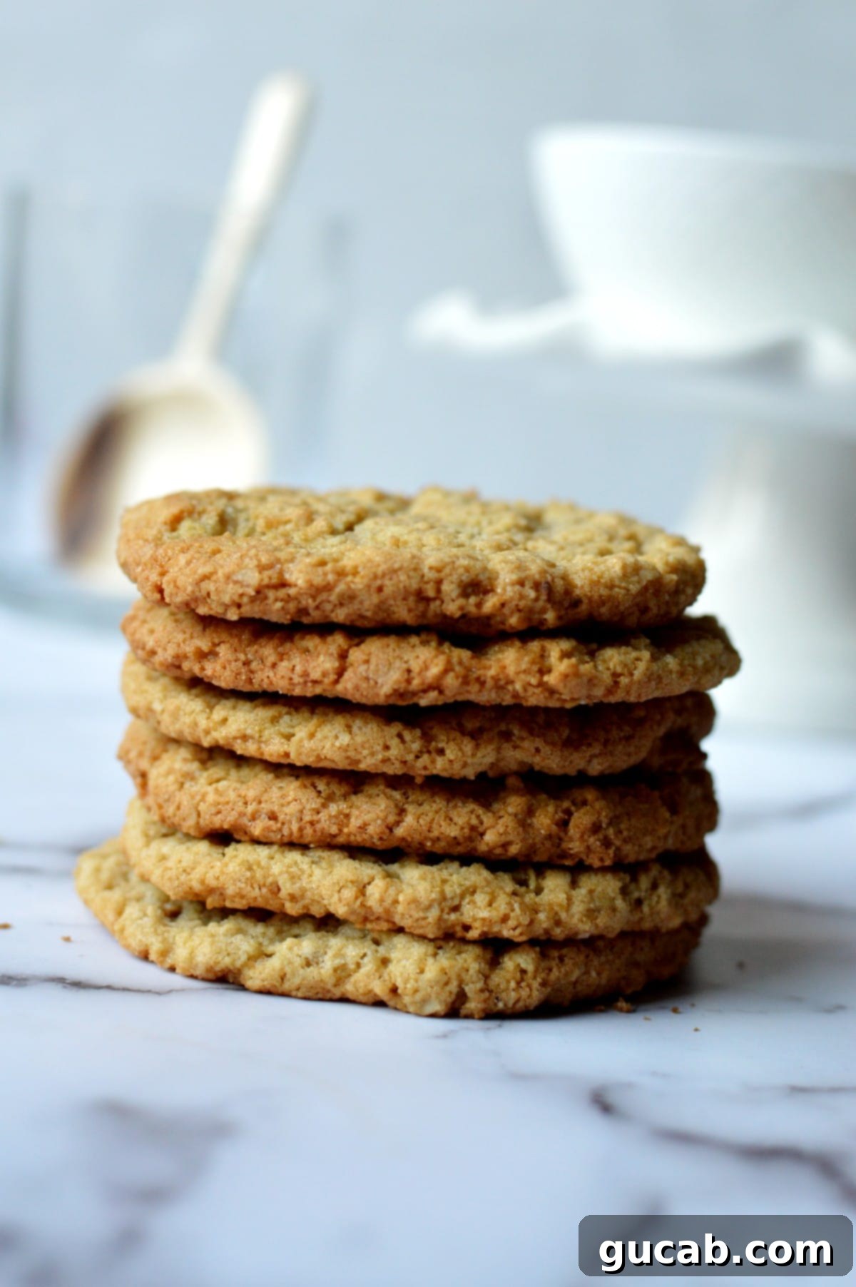 A stack of golden almond flour oatmeal cookies with visible oats