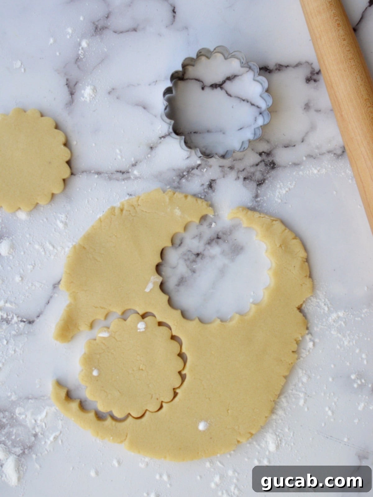 Buttery Almond Flour Shortbread 6 Cookie dough rolled out and cut into shapes on a baking sheet