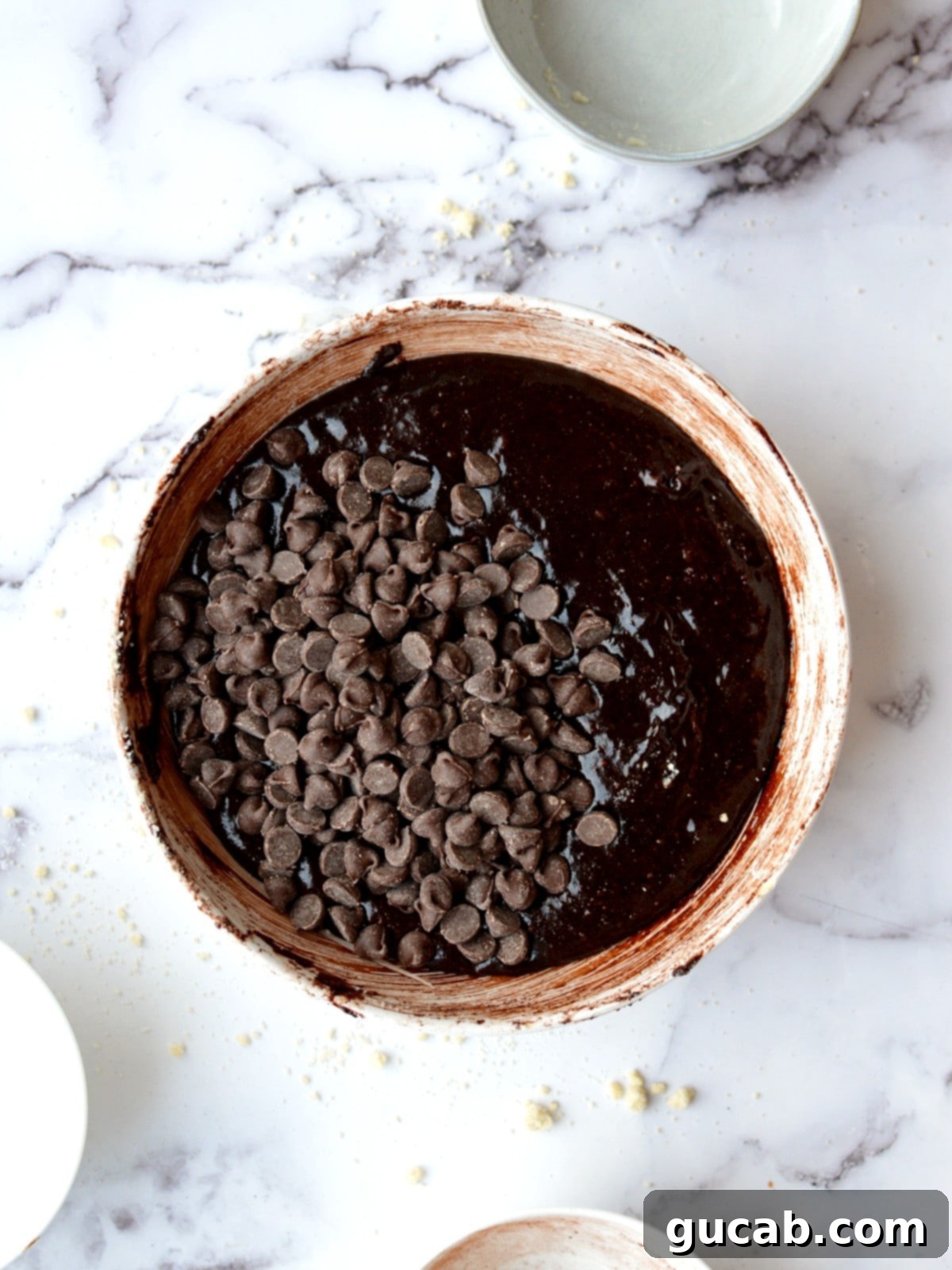 Almond flour brownie batter studded with semisweet chocolate chips, ready for baking.