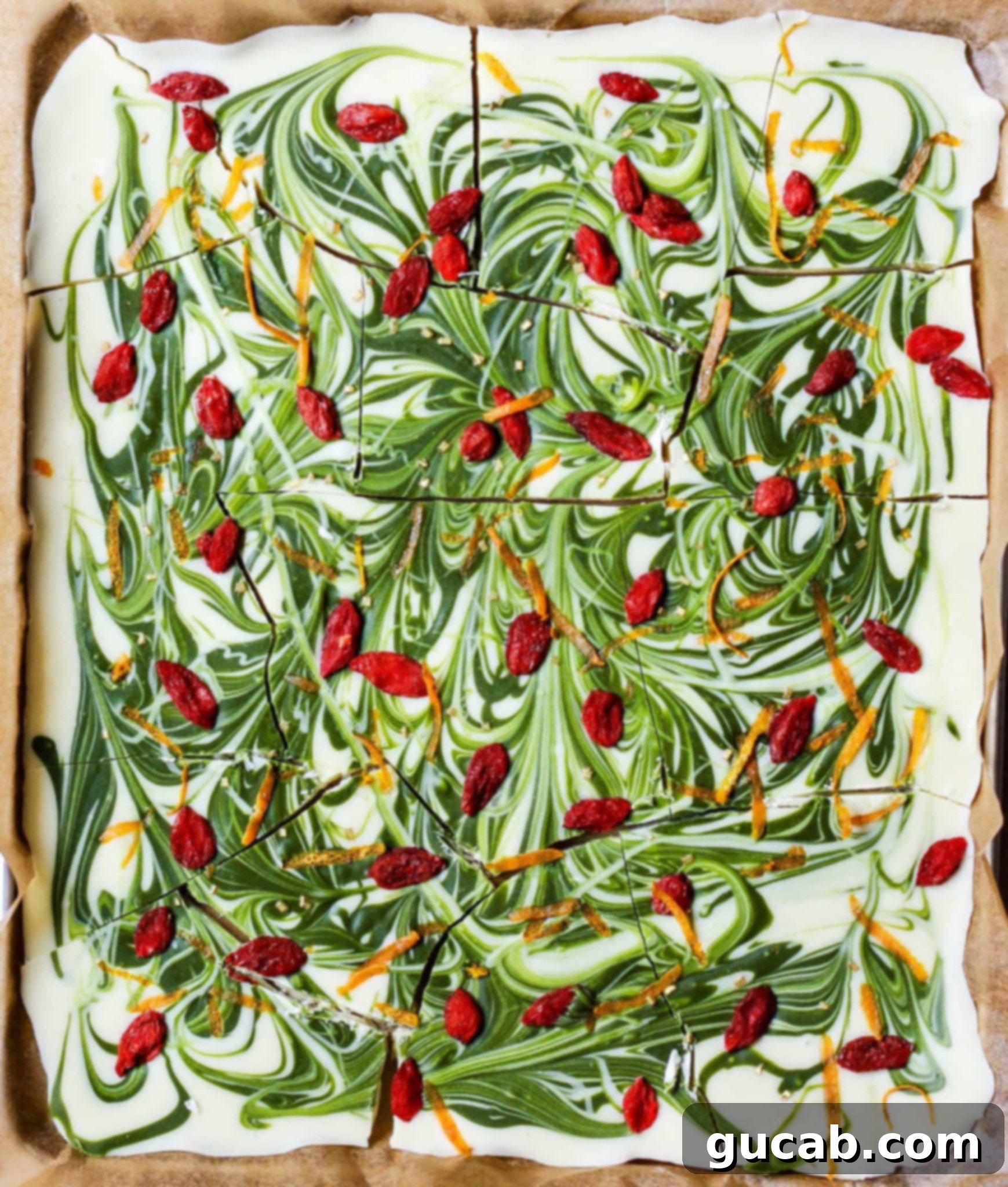 Visually appealing matcha white chocolate bark, adorned with pistachios and dried cranberries.