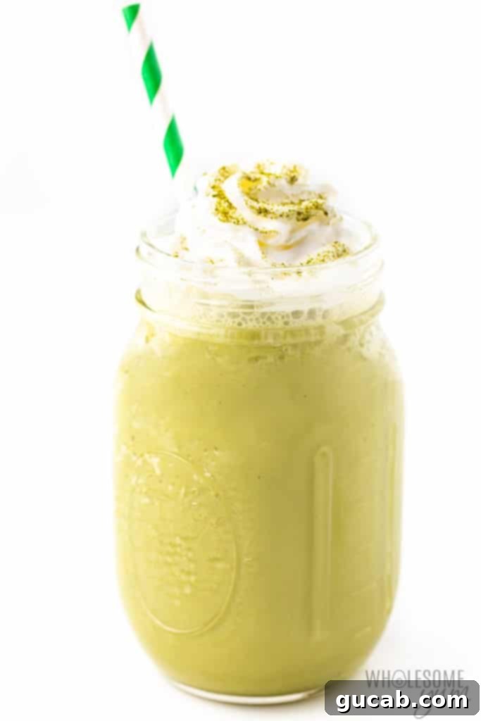 A refreshing keto matcha green tea frappe, topped with whipped cream, resembling a coffee shop favorite.