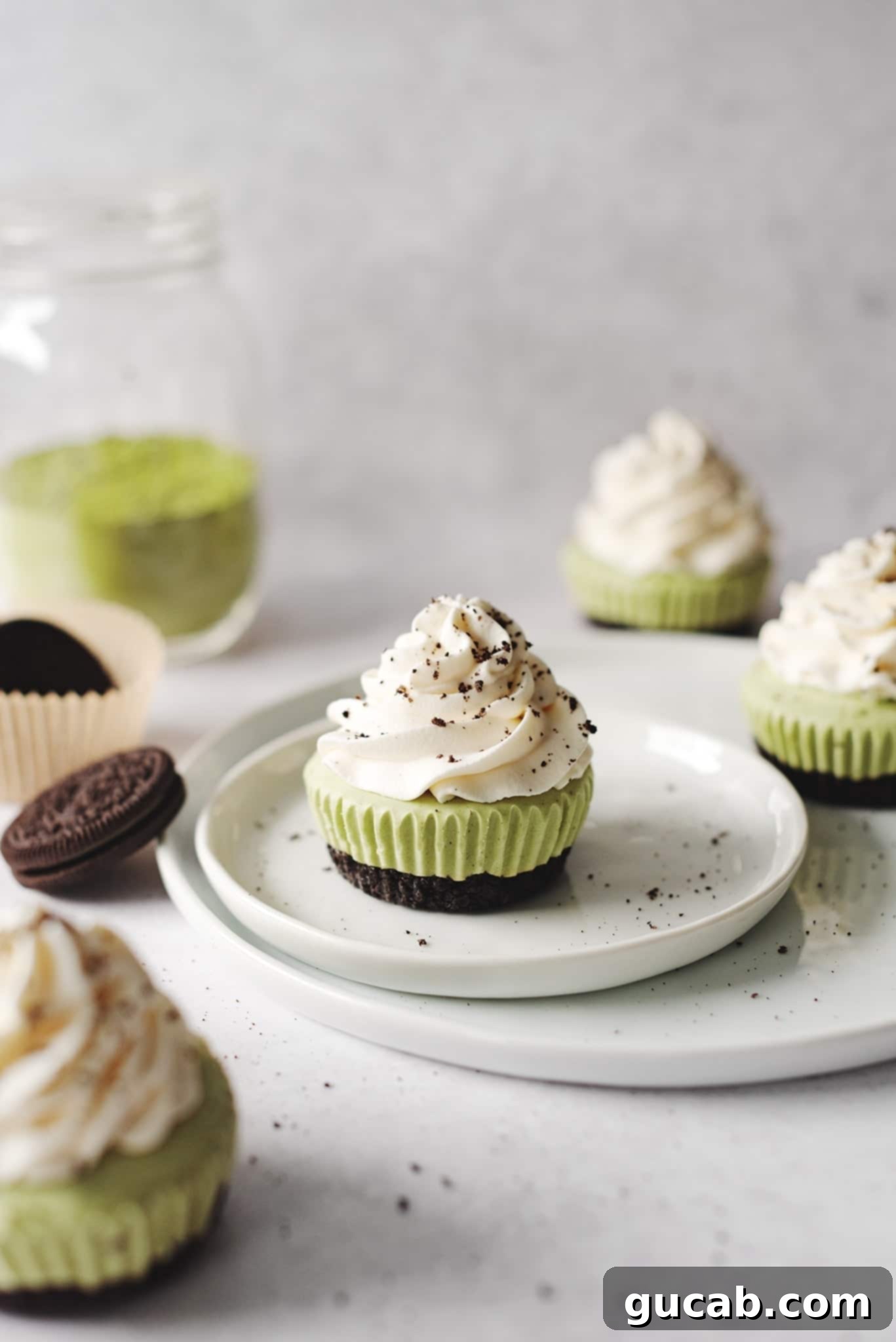 Mini matcha cheesecakes with an Oreo crust, offering a delightful no-bake dessert option.