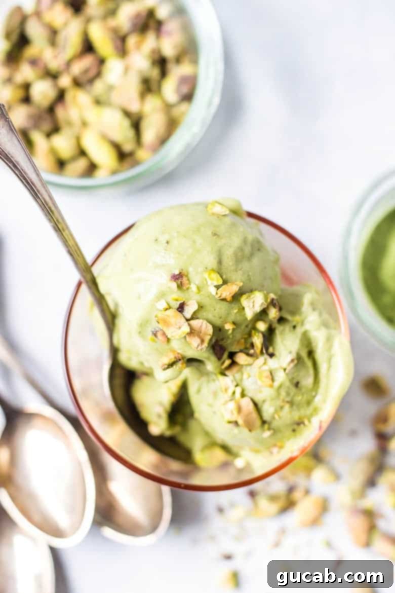 A scoop of vibrant vegan pistachio matcha ice cream, a healthy and refreshing treat.