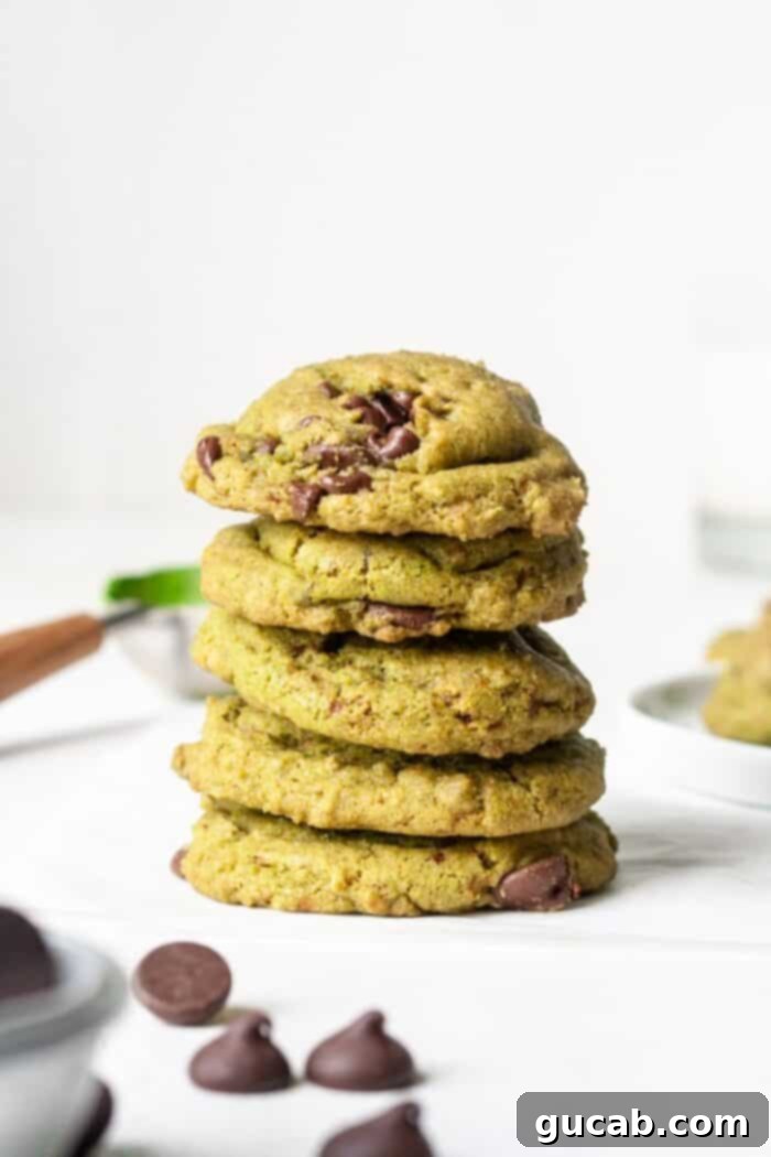A stack of chewy matcha chocolate chip cookies, showcasing the delightful green hue and chocolate chunks.