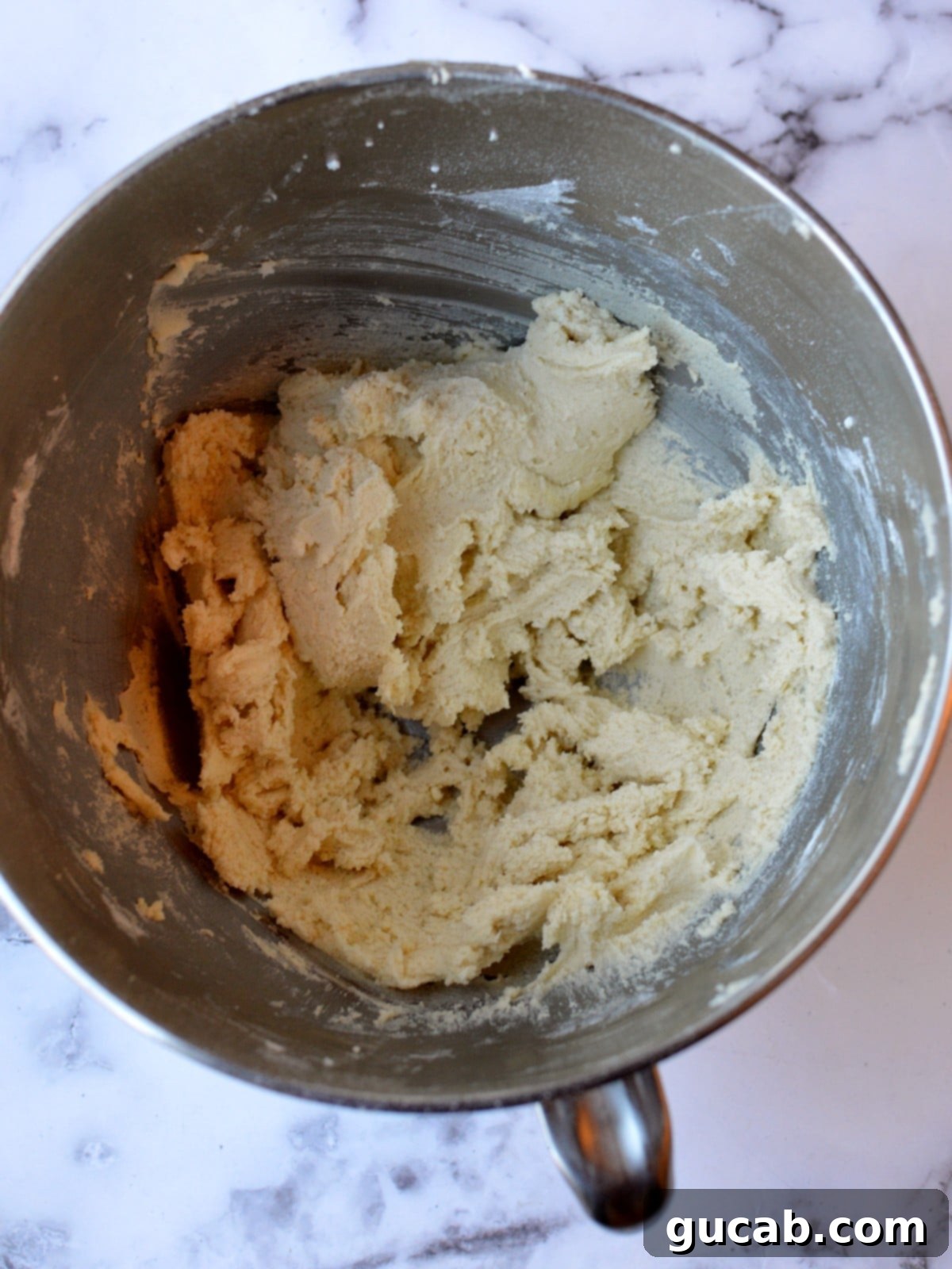 A bowl of freshly mixed gluten-free snickerdoodle cookie dough, ready for shaping