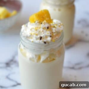 Creamy pineapple milkshake with whipped cream and a pineapple wedge
